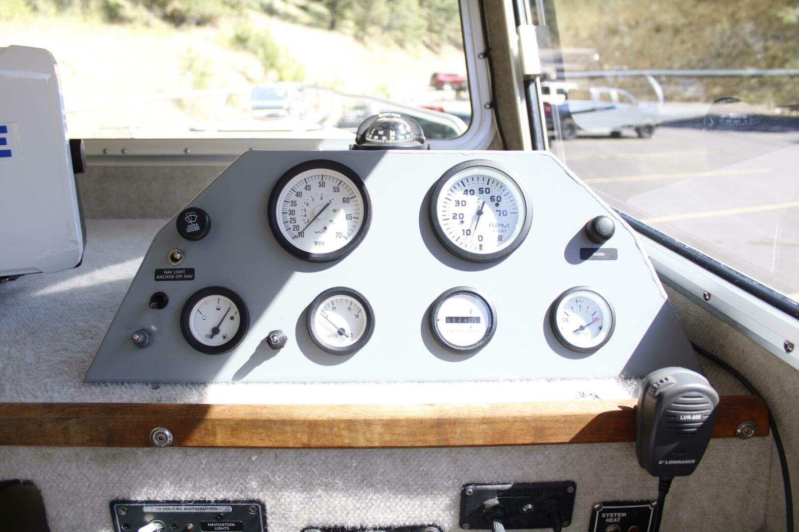 Control panel of a 2005 ACB 27 boat with gauges and switches.