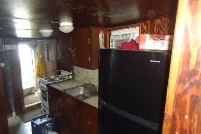 1973 Commercial Boats Shrimp Trawler kitchen interior with wooden cabinets and appliances.