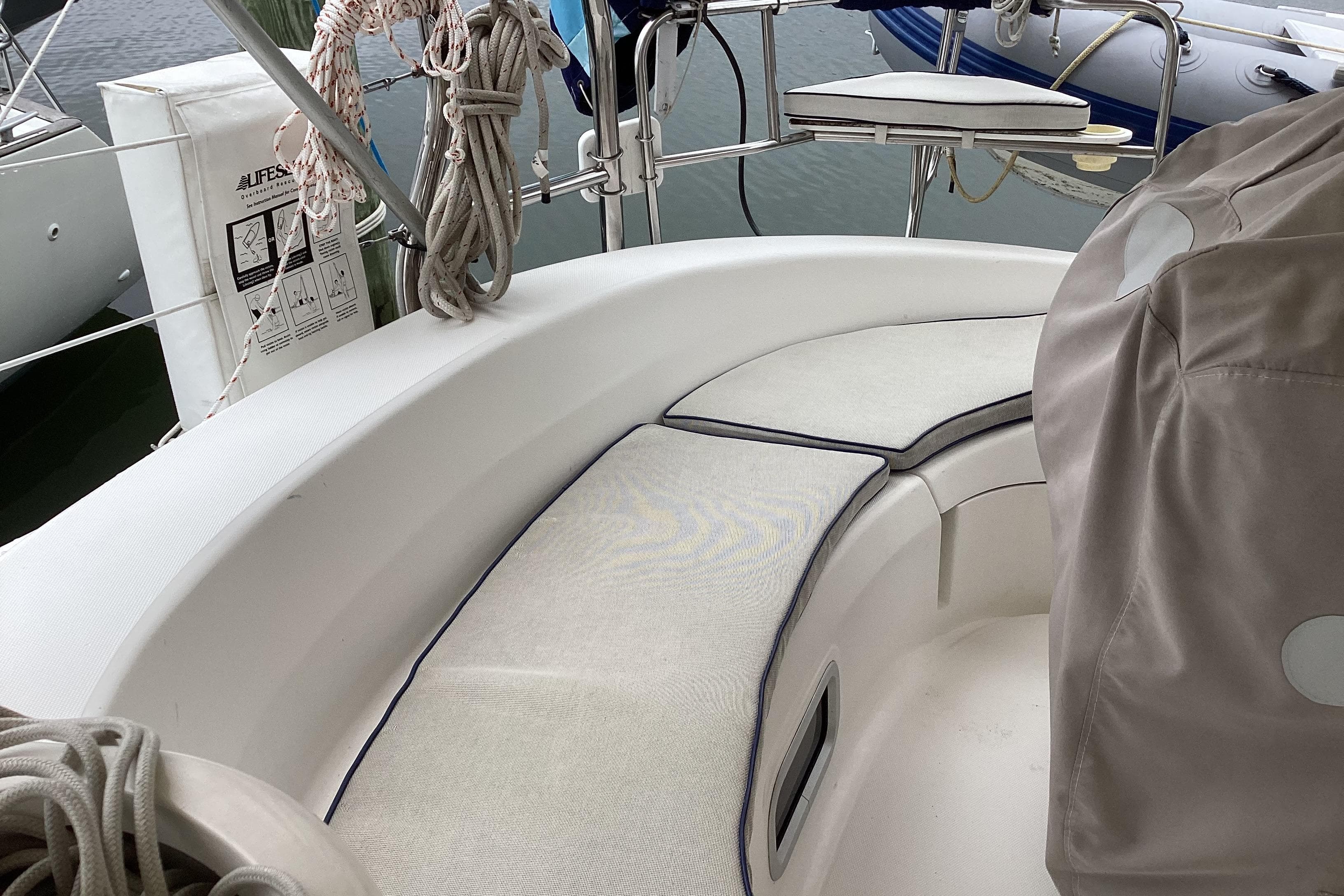 Cockpit of 2001 Hunter 380 sailboat with cushioned seating and nautical equipment.