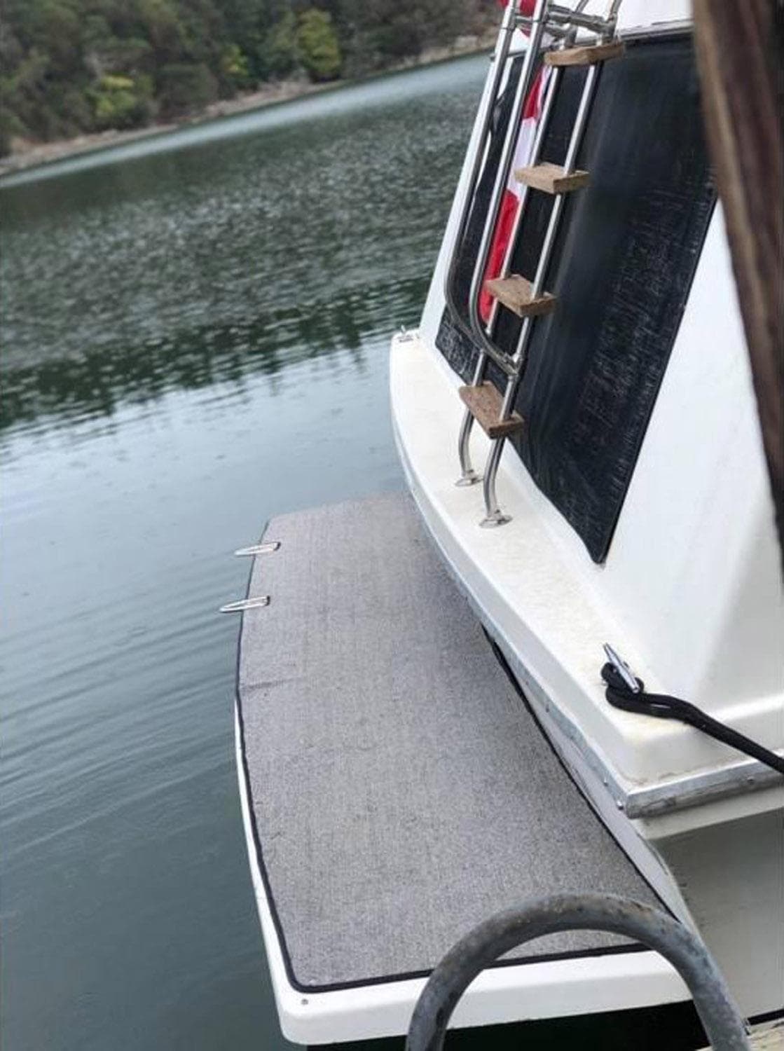 1985 Bluewater Yachts 51 Coastal Cruiser, rear view with swim platform on calm water.