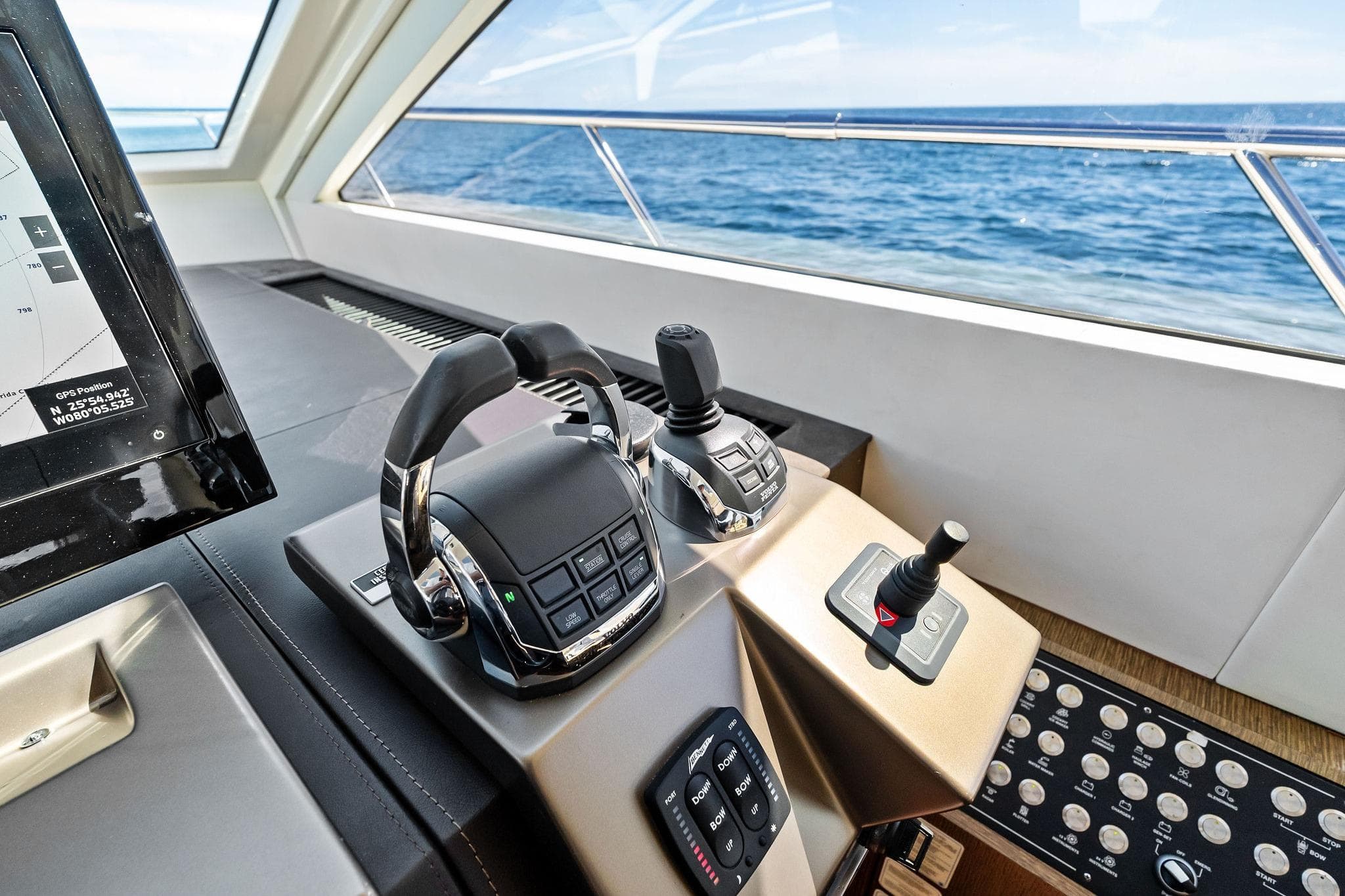 Control panel of a 2013 Absolute 64 yacht with ocean view.