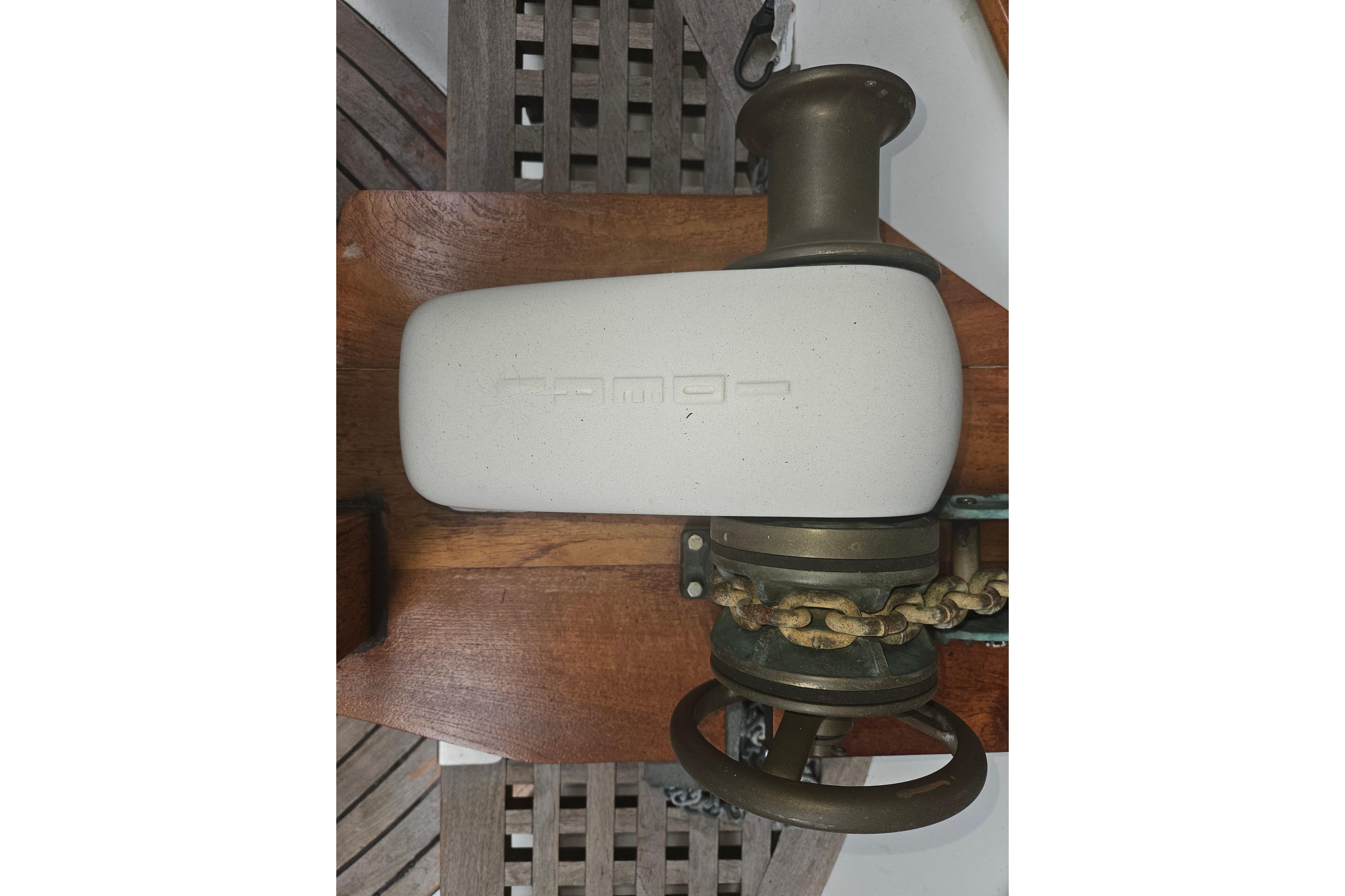 Vintage CHB 34 boat windlass from 1978 with chain and wooden base.