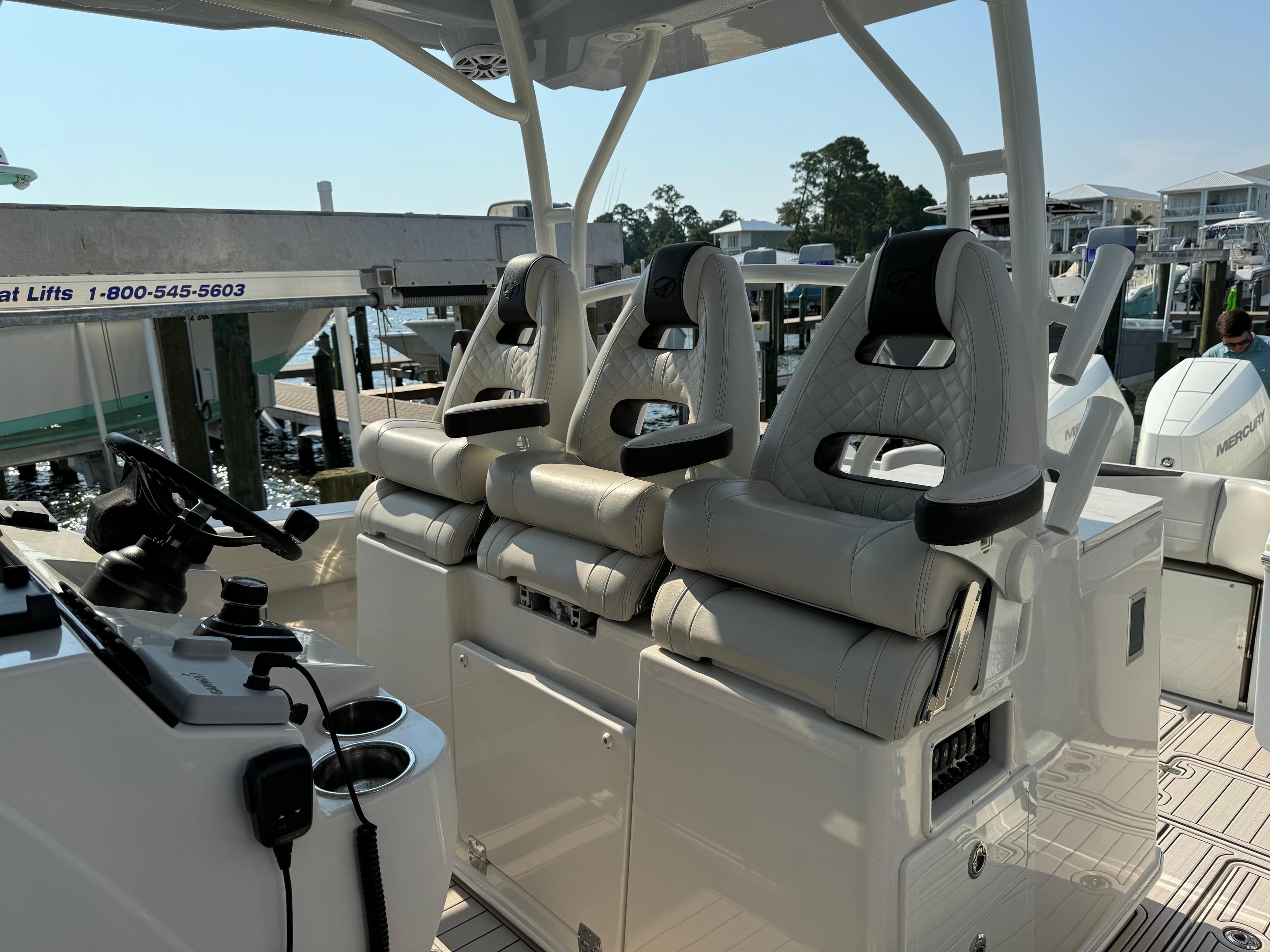 2024 Sailfish 360 CC boat interior with three cushioned seats and steering console.