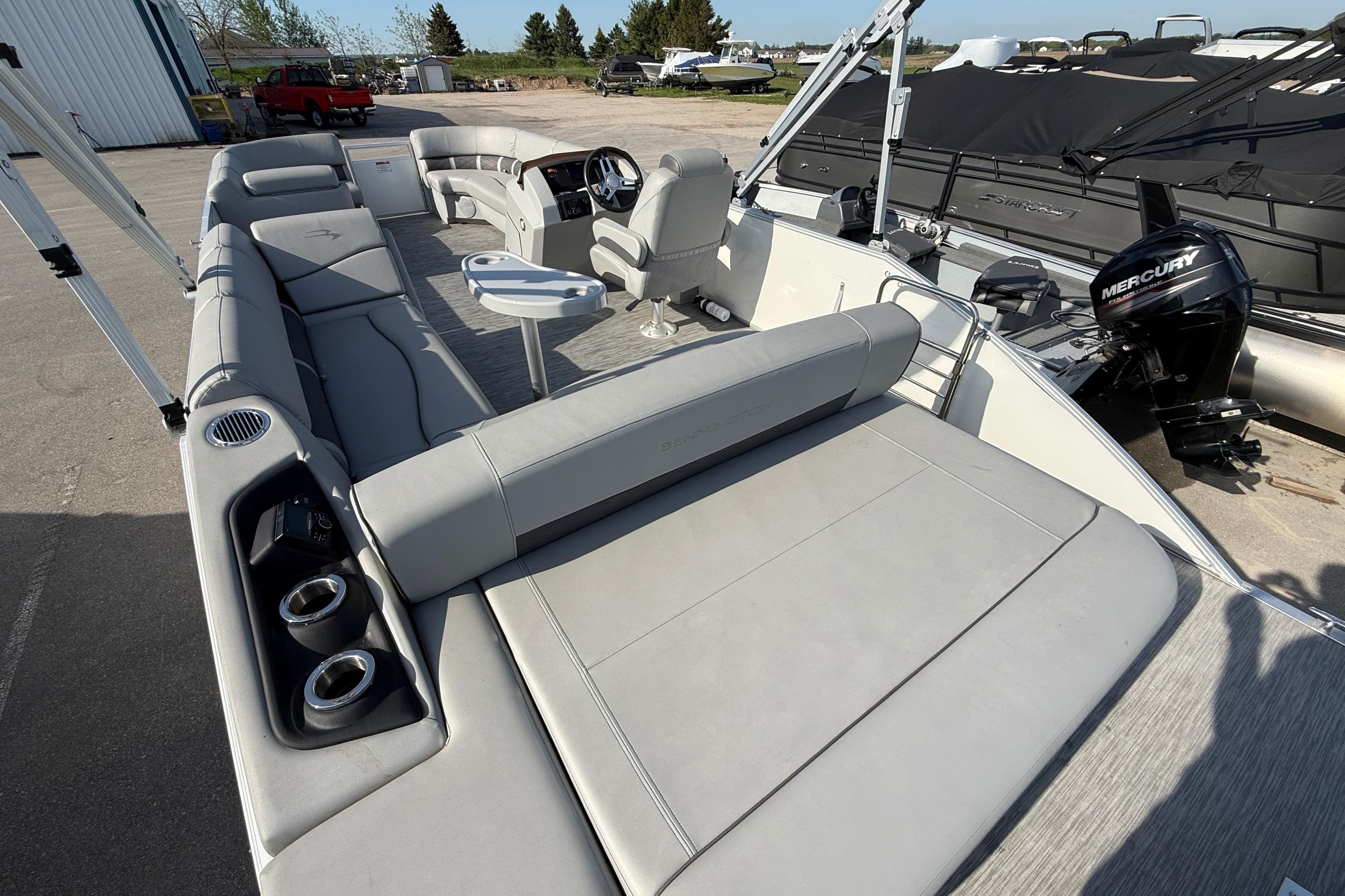 2021 Bennington 25 SSBXSD pontoon boat with spacious seating and Mercury outboard motor.