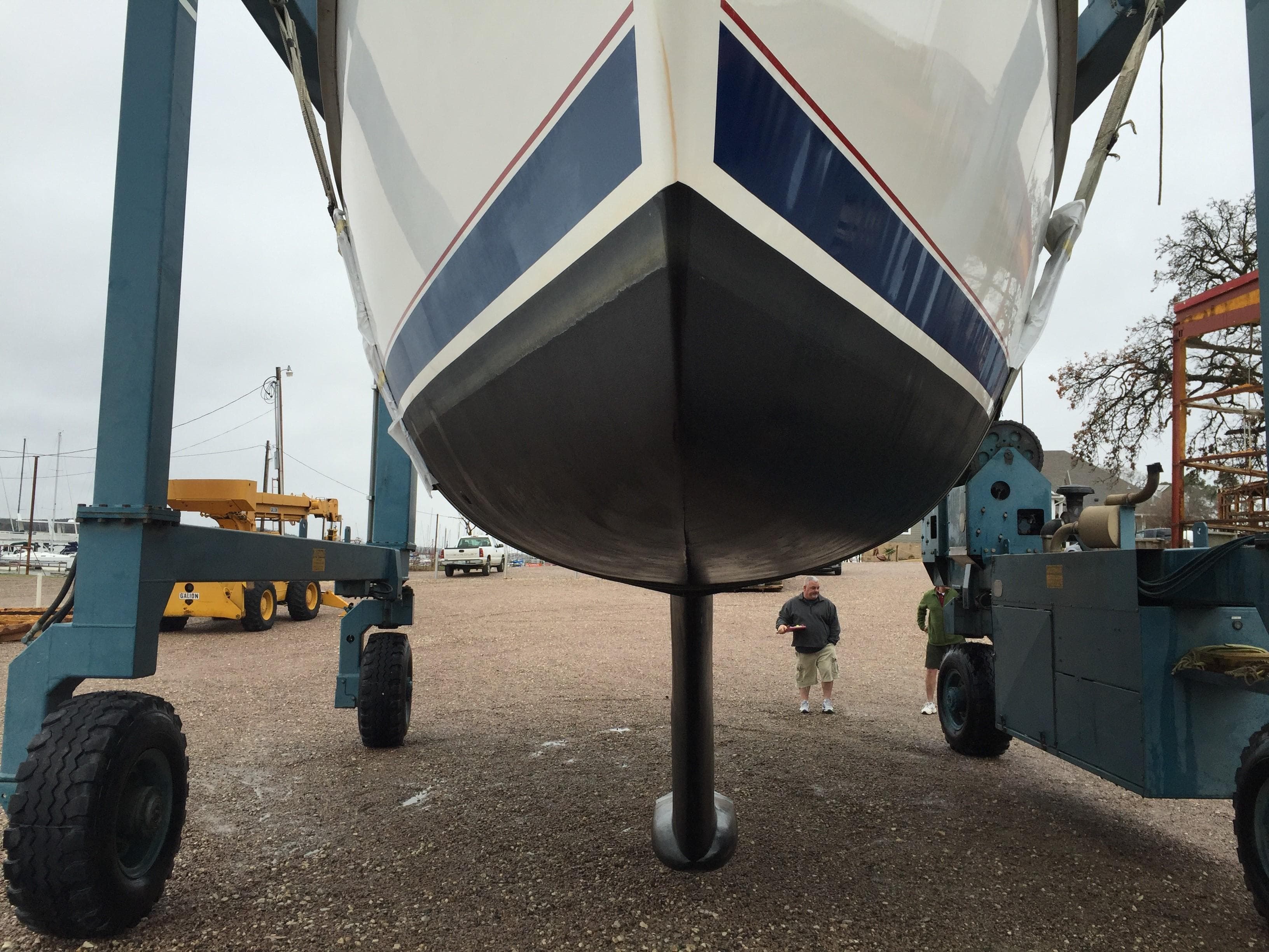 Hunter 376 sailboat from 1997 on a boat lift, showing keel and hull.