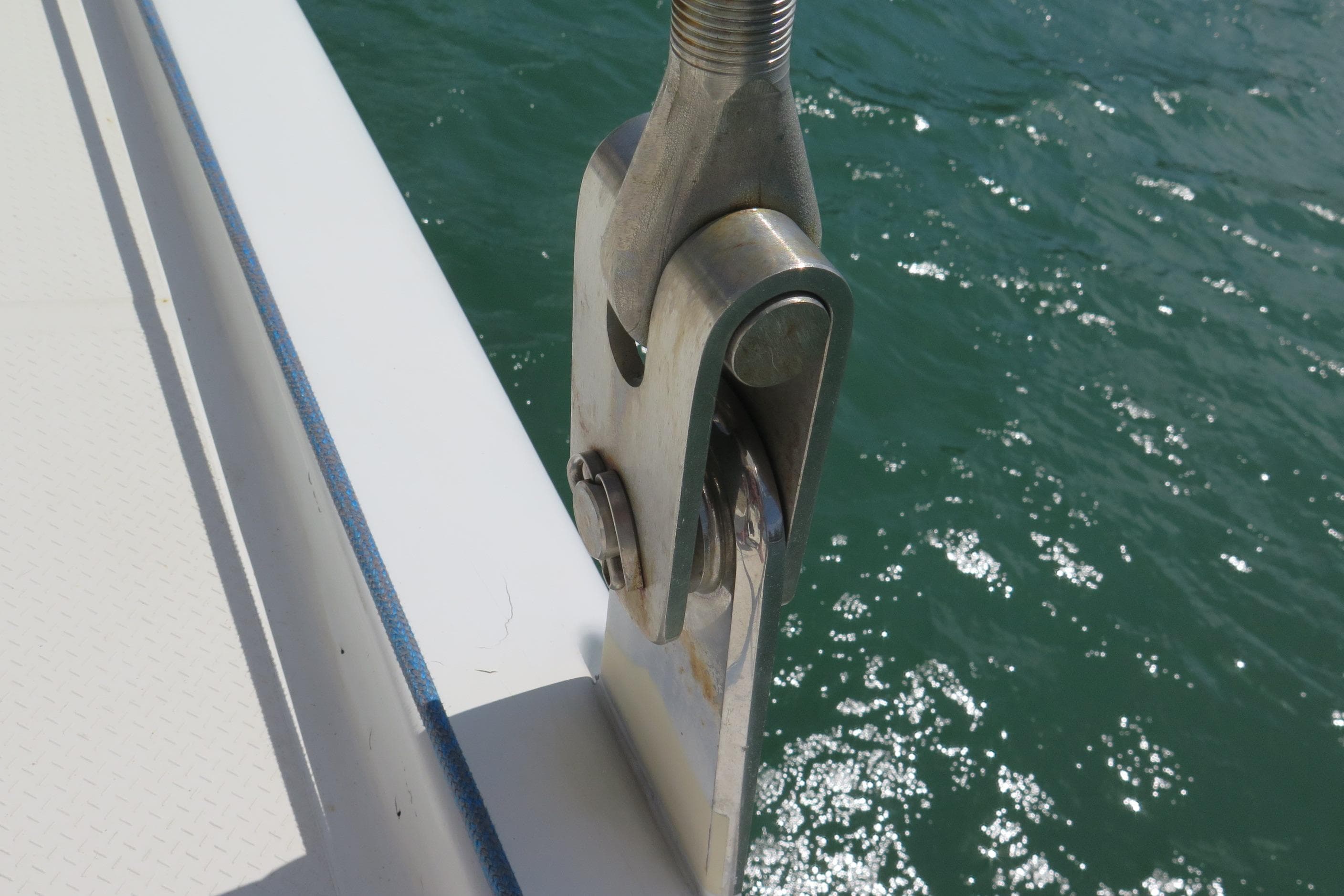 Close-up of a 2013 Fountaine Pajot Helia 44 yacht's rigging detail over water.