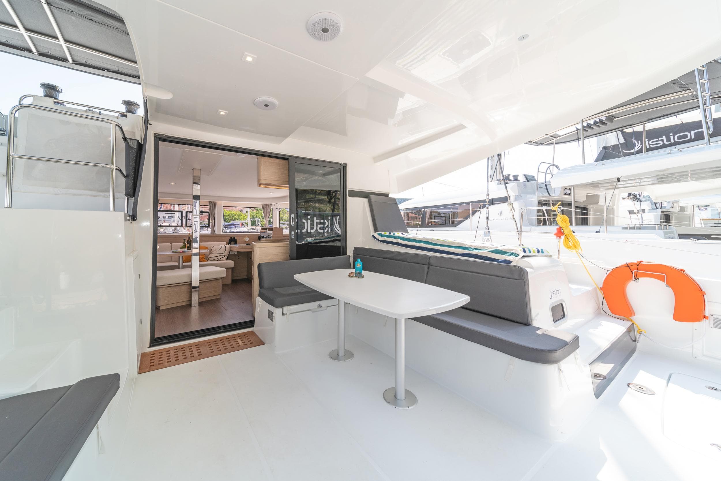 2023 Lagoon 42 yacht interior with modern seating and dining area.