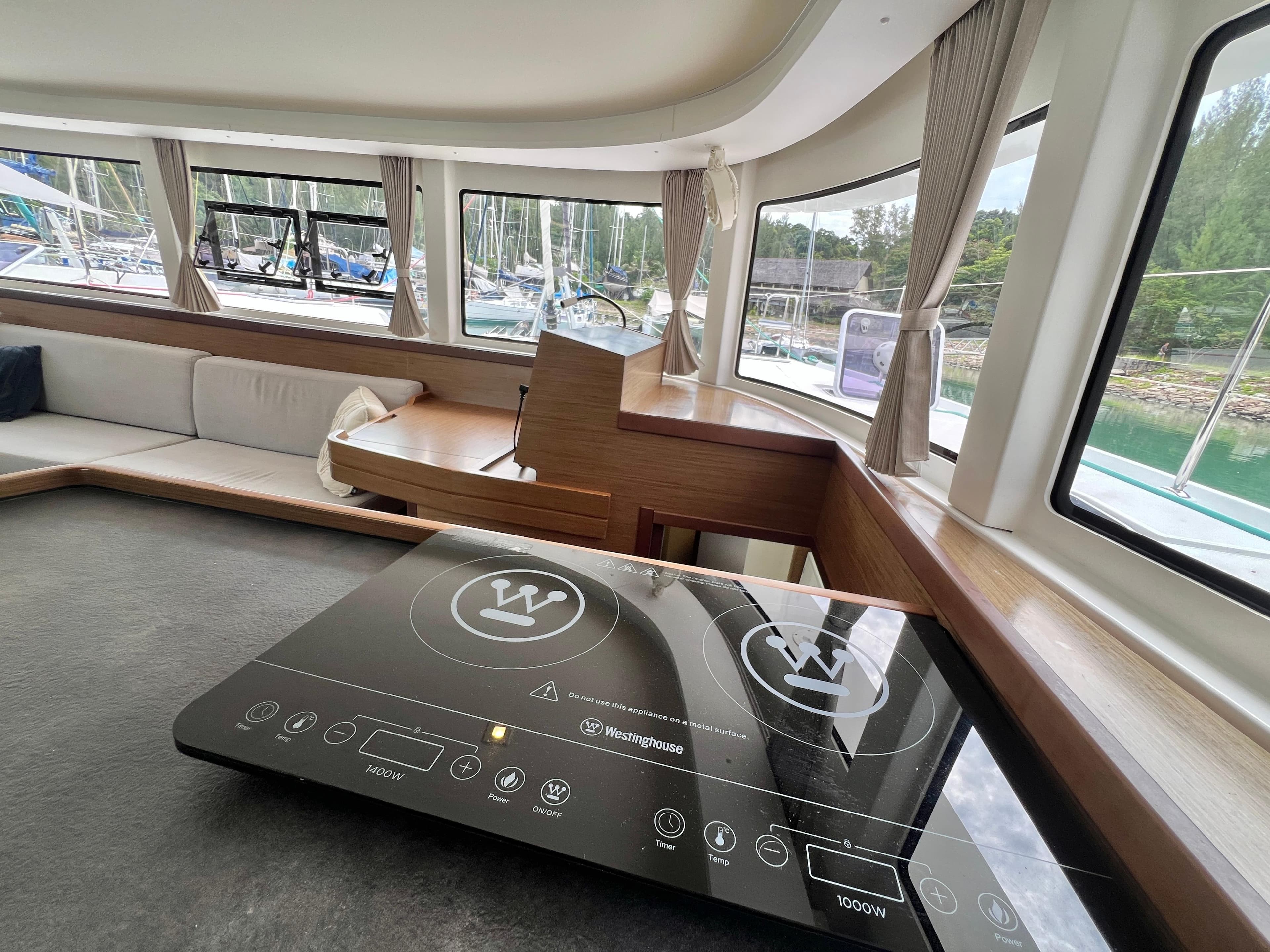 Interior of 2020 Lagoon 42 yacht with modern kitchen and spacious seating area.