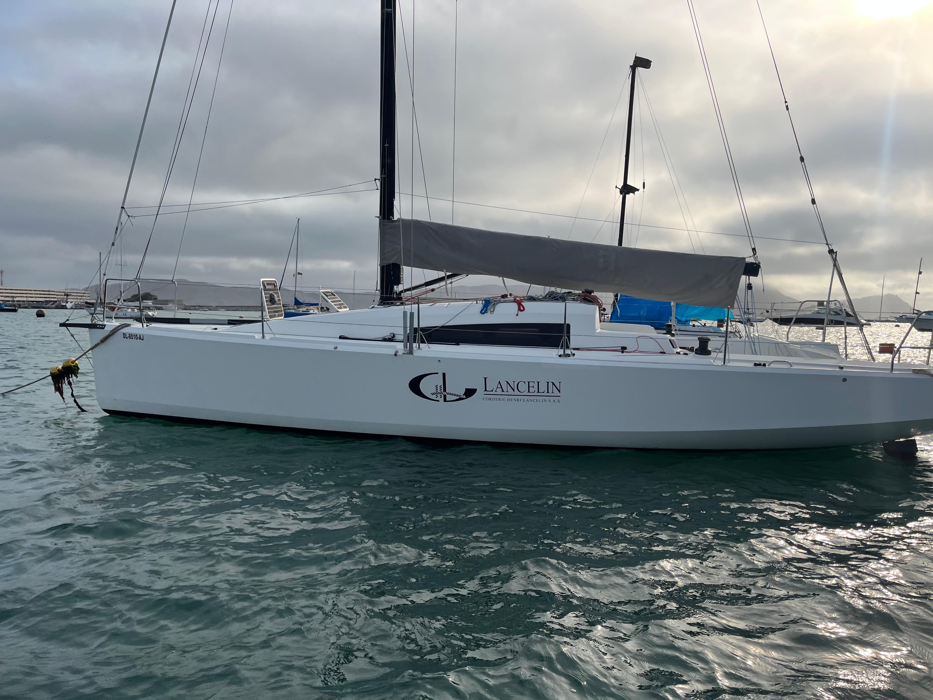 Jeanneau Sun Fast 3600 sailboat, 2013 model, anchored in calm waters under a cloudy sky.