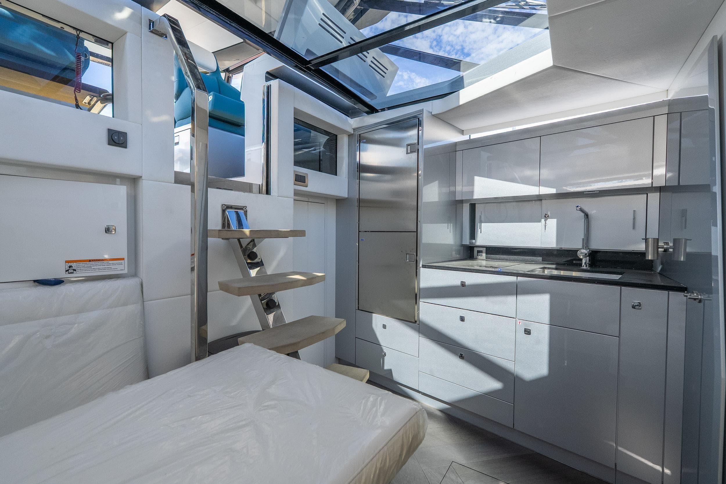 Modern interior of 2026 Dutch American DA 53 yacht with sleek kitchen and skylight.