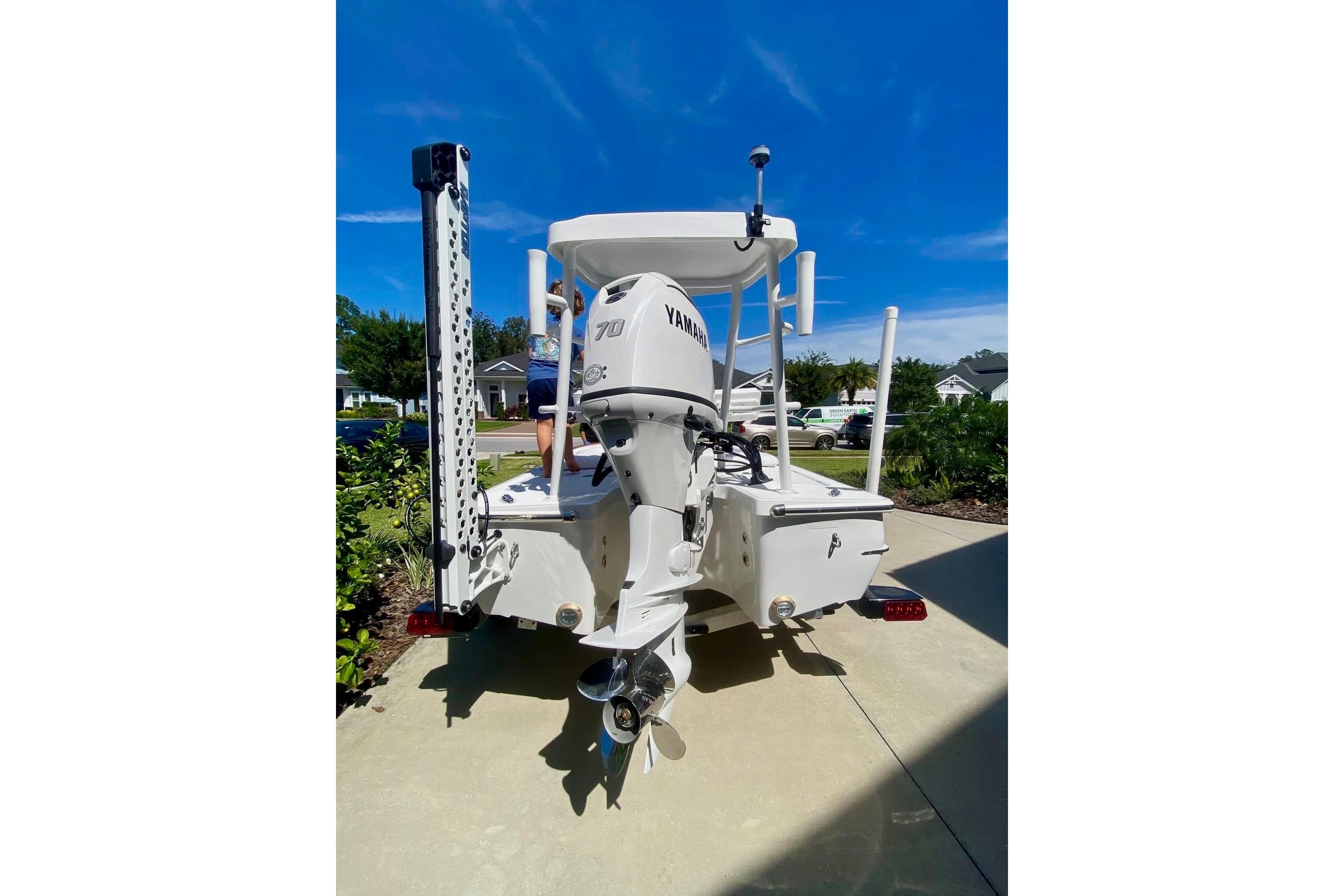 2026 Chaos 16 Bonefish boat with Yamaha engine, parked on driveway under clear blue sky.