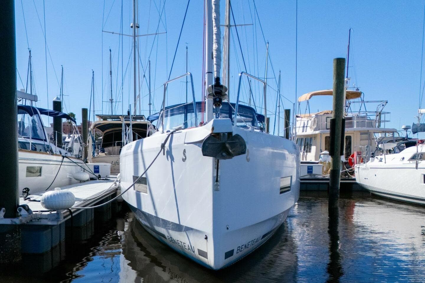 2022 Beneteau Oceanis 40.1 yacht docked at marina under clear blue sky.