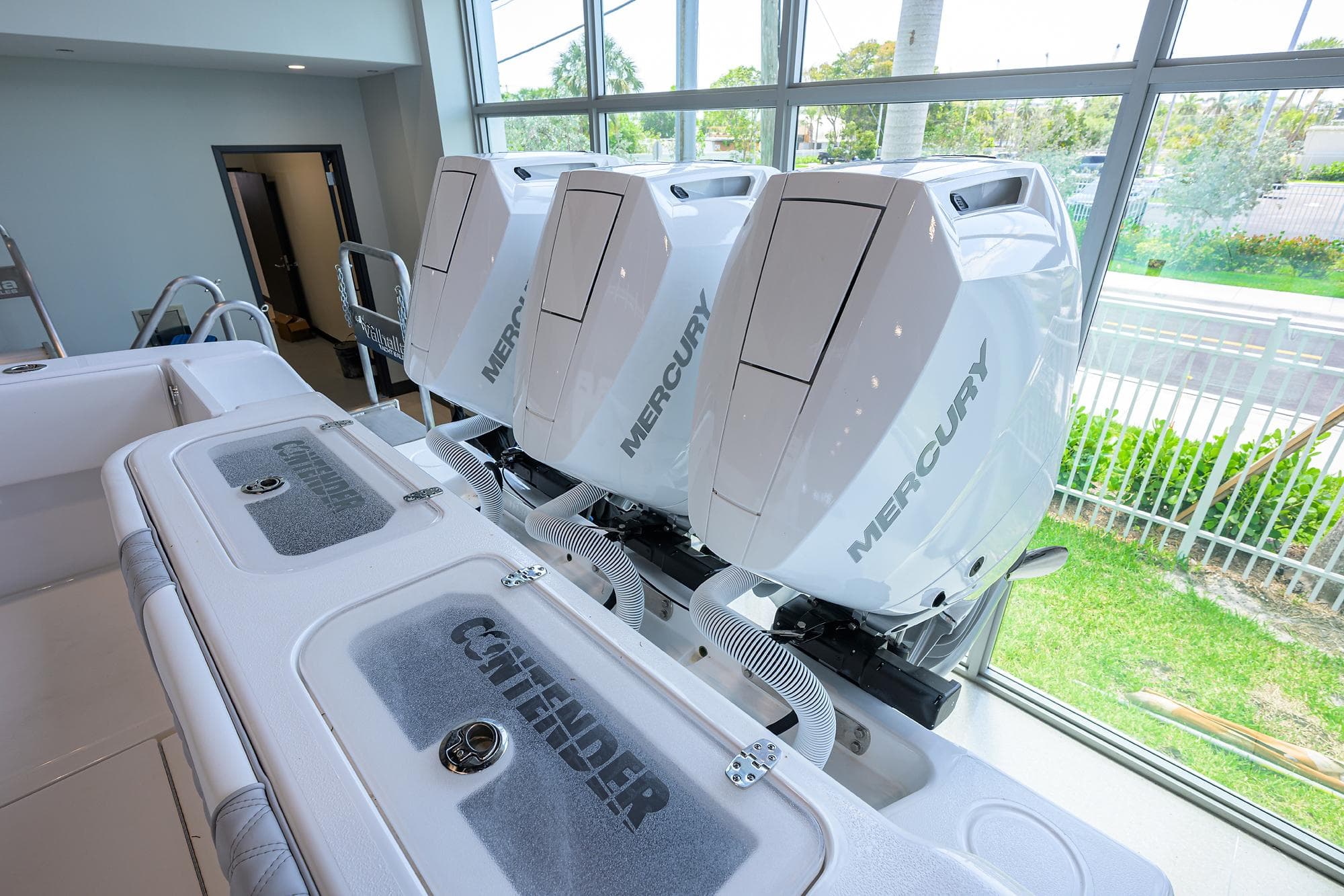 2025 Contender 39 ST boat with triple Mercury outboard engines in showroom.