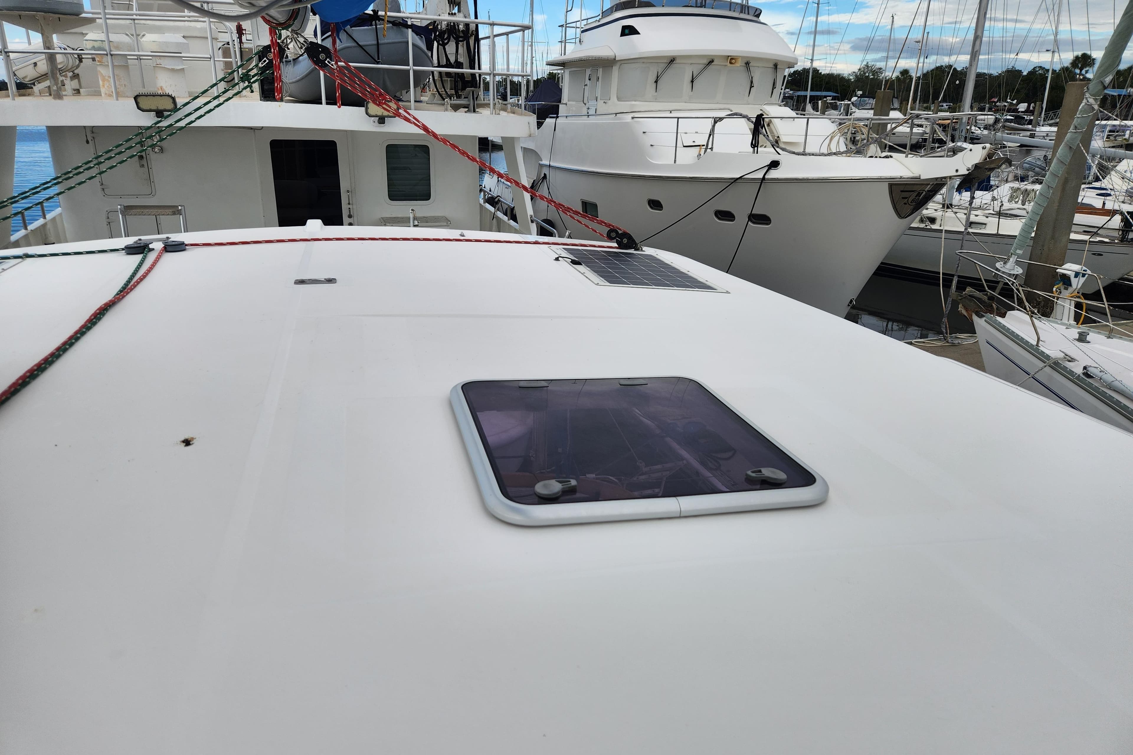 2015 Leopard 44 yacht deck with hatch, docked in a marina.