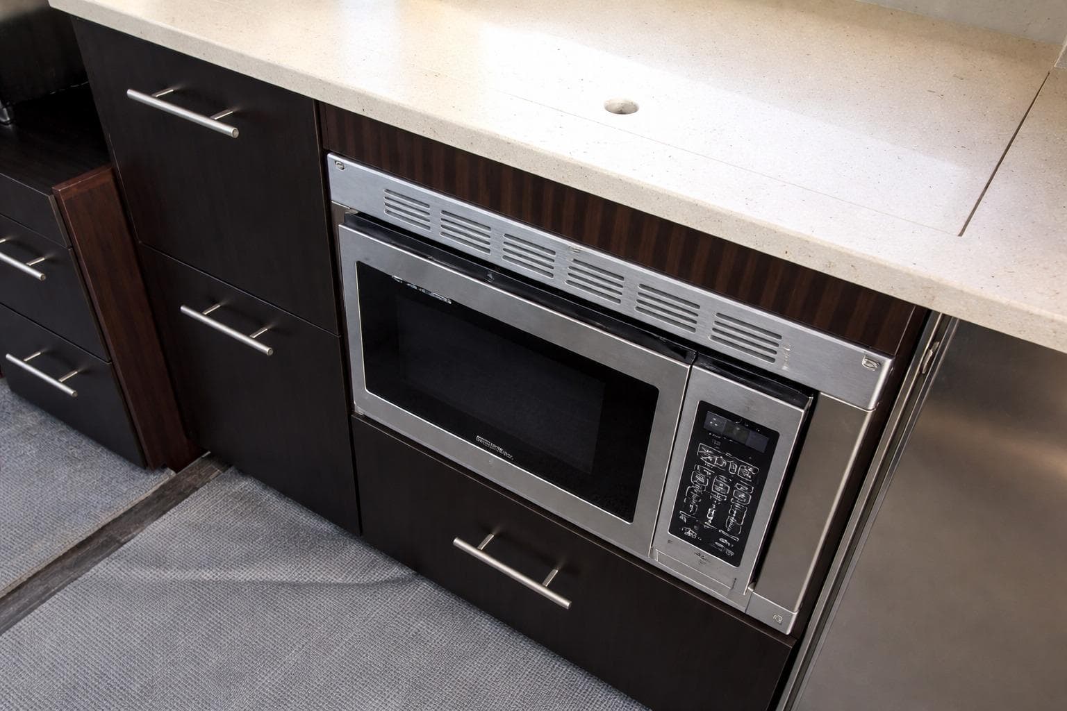 Modern kitchen area in 2019 Regal 42 Grande Coupe yacht with built-in microwave.