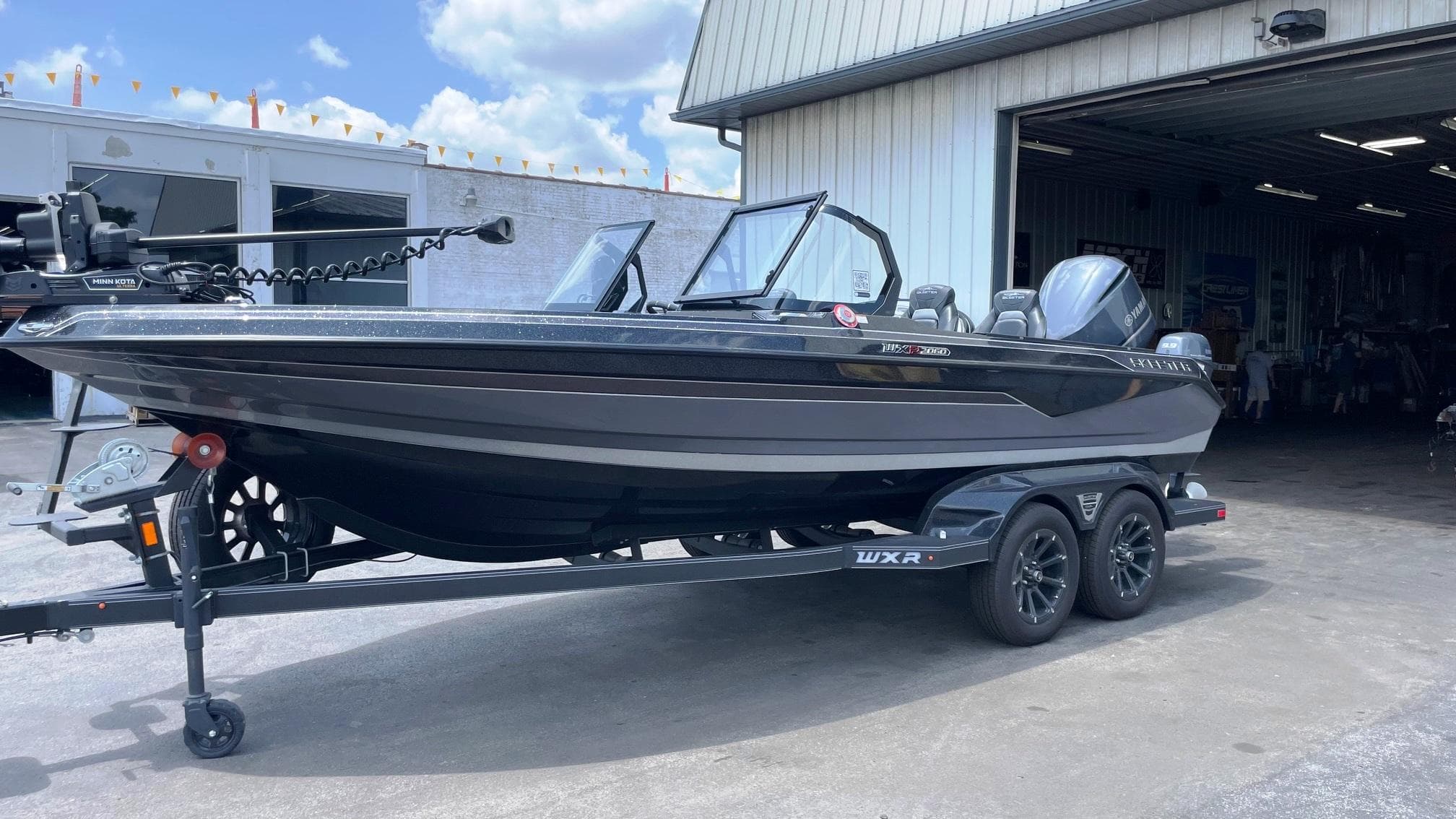 2025 Skeeter WXR 2060 boat on trailer outside a garage.