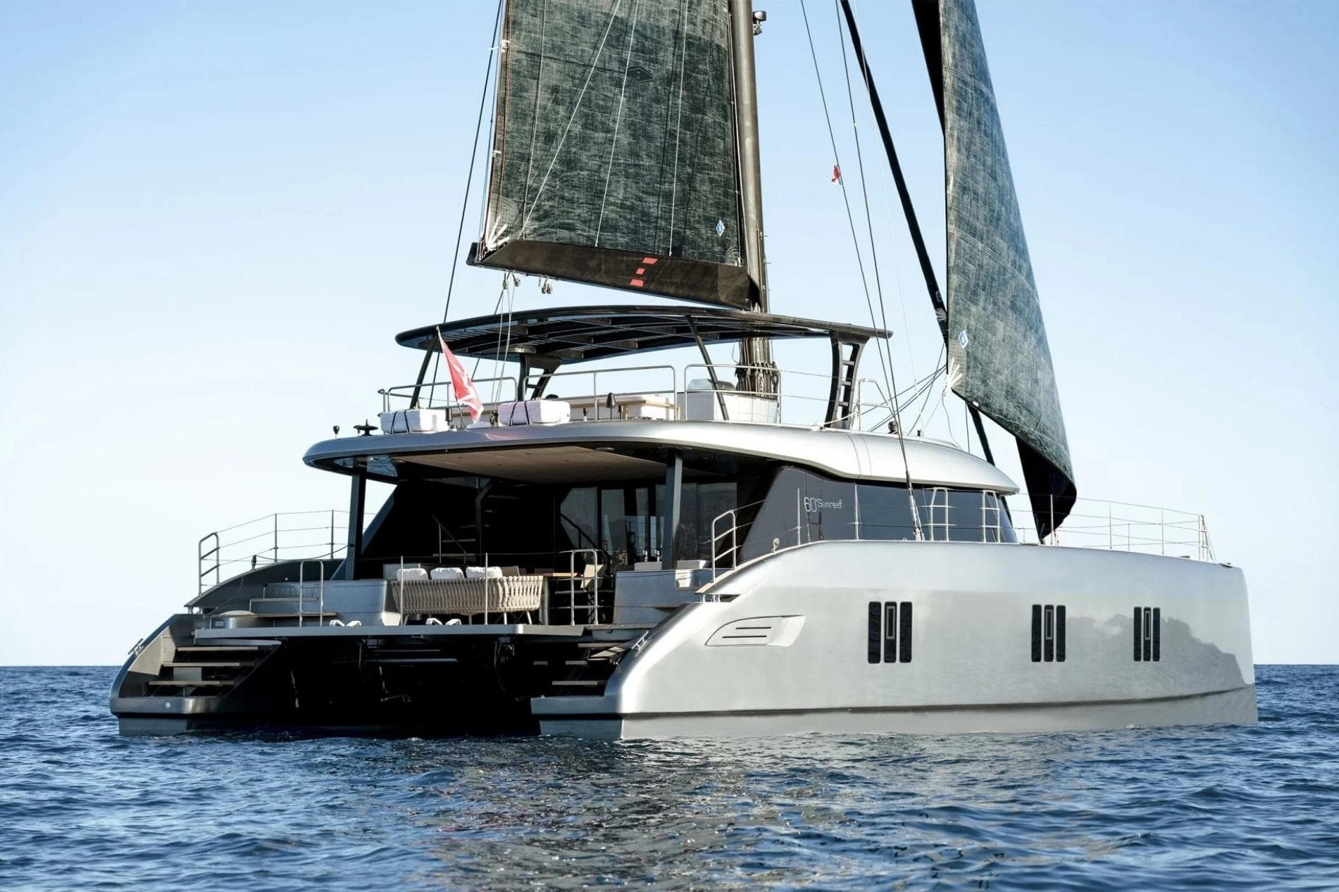 2024 Sunreef 60 yacht sailing on open water, showcasing sleek design and luxury features.