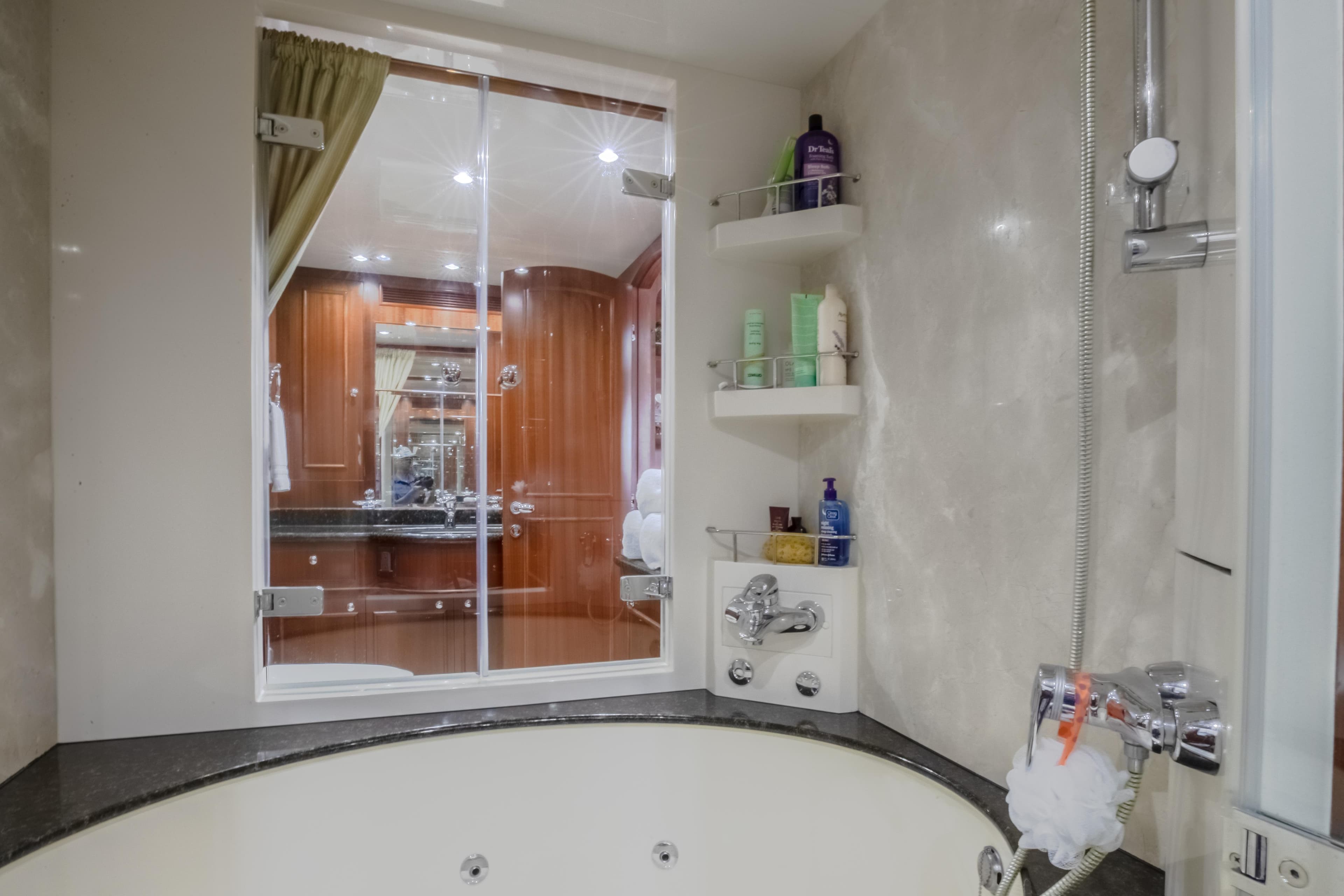 Luxurious bathroom on a 2005 Horizon 94 Motoryacht with a jacuzzi tub and modern fixtures.