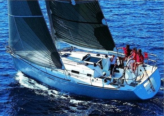 2003 Beneteau First sailboat navigating blue ocean waters with crew on deck.