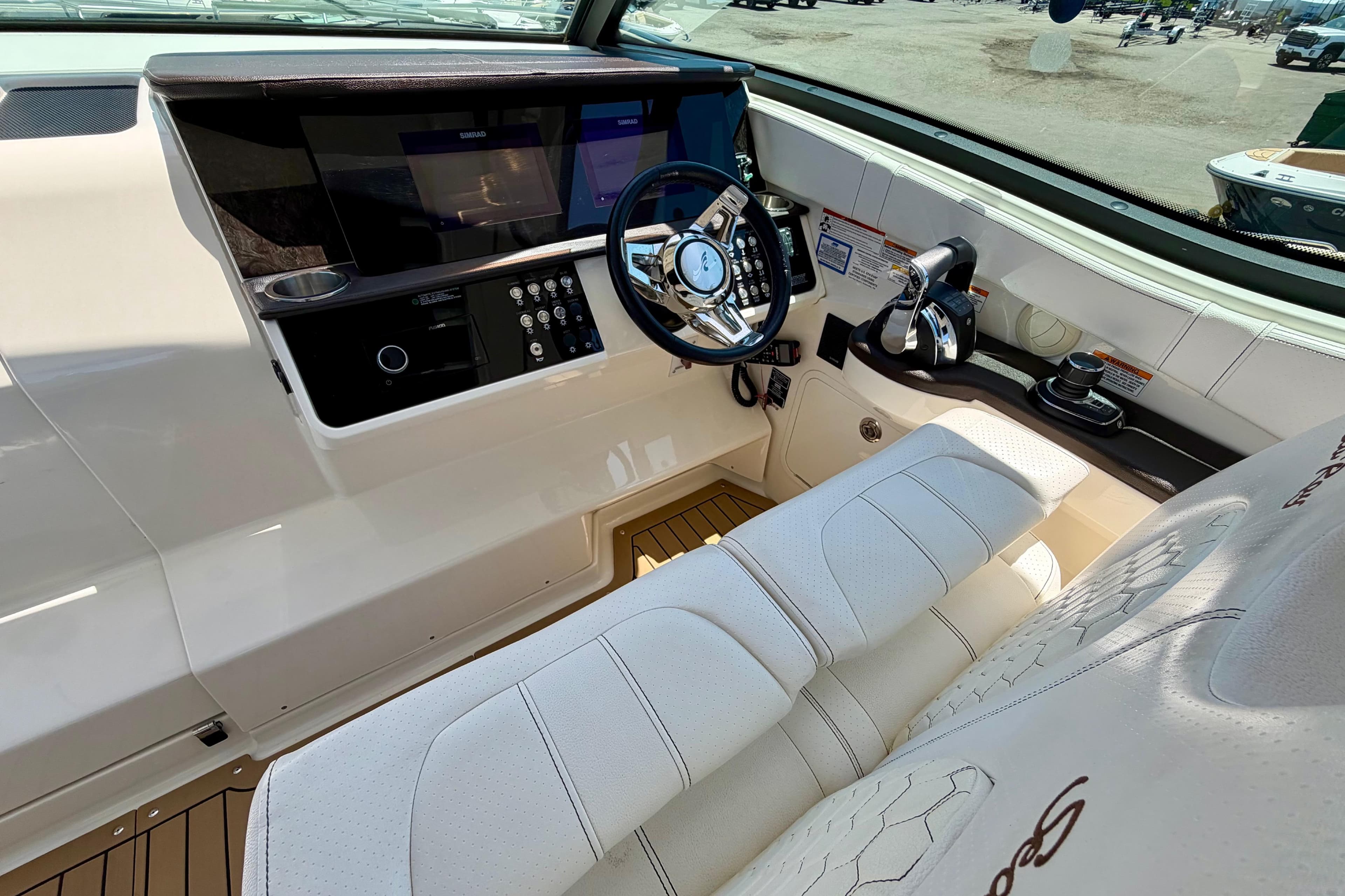 2019 Sea Ray Sundancer 320 helm with modern controls and luxurious seating.