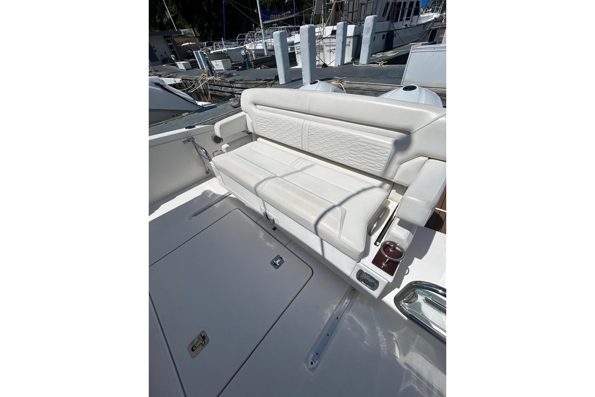 2021 Tiara Yachts 34 LS with luxurious white seating at the dock.
