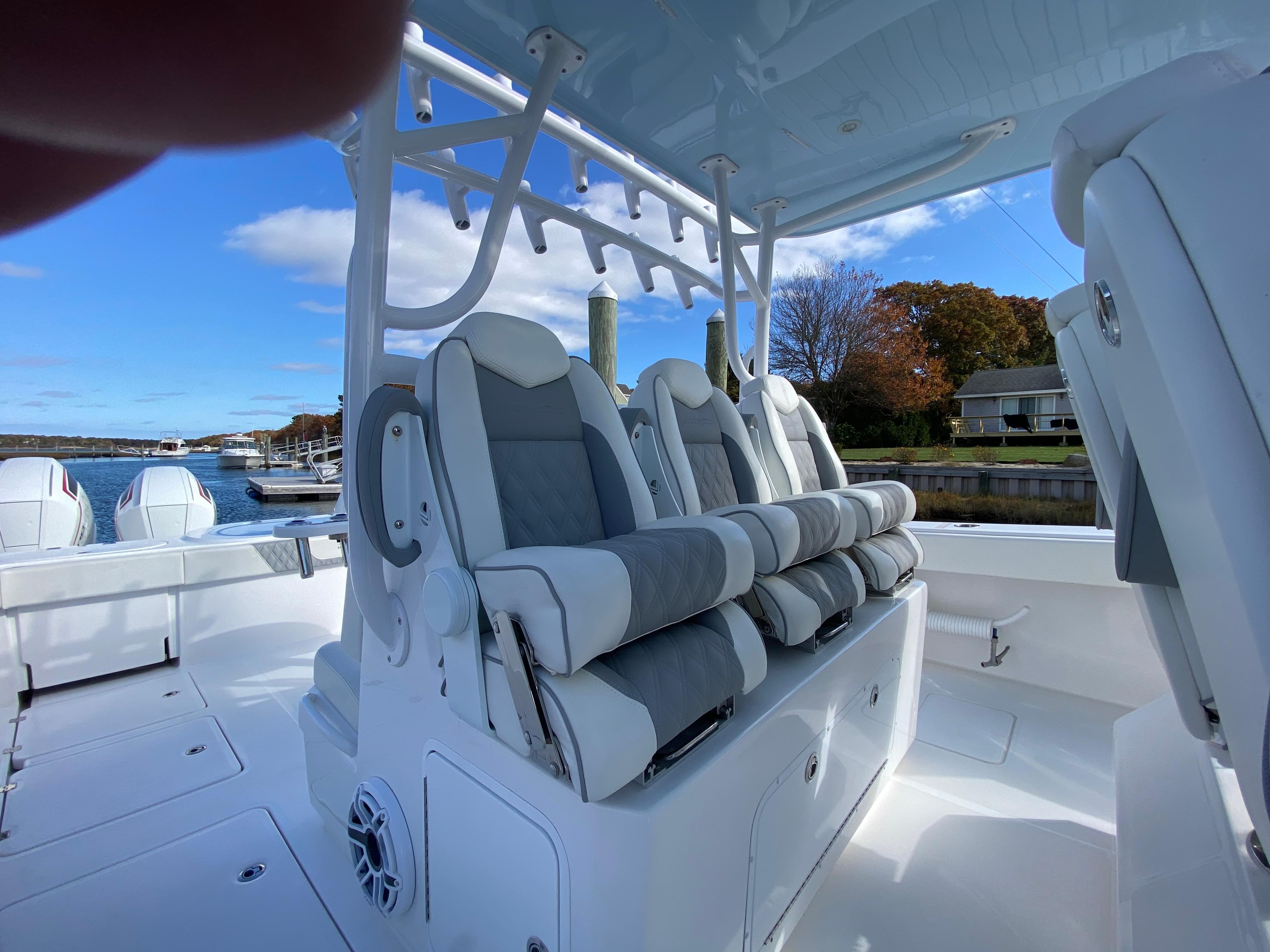 2023 Invincible 46 Catamaran Plus Quad Axle Trailer with luxurious seating on deck.