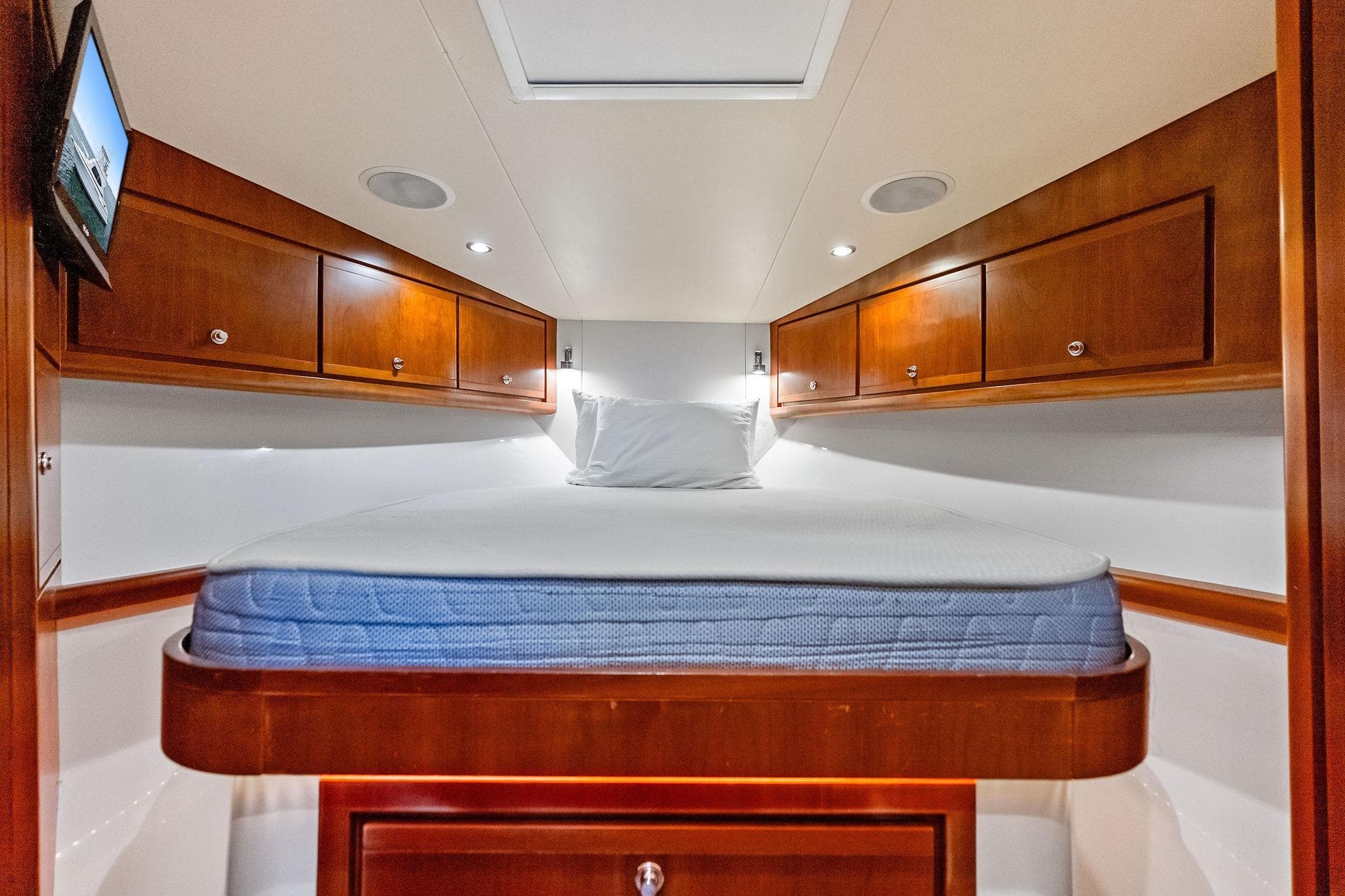 Luxurious cabin interior of 2006 Bertram 39 Convertible yacht with wooden cabinetry.