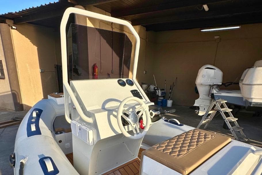 2026 Maro Boats M561 with modern helm and seating in a garage setting.