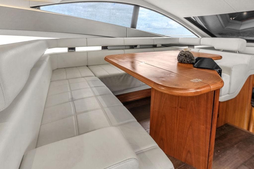 Luxurious interior of 2016 Sunseeker Manhattan 55 yacht with elegant seating and wooden table.