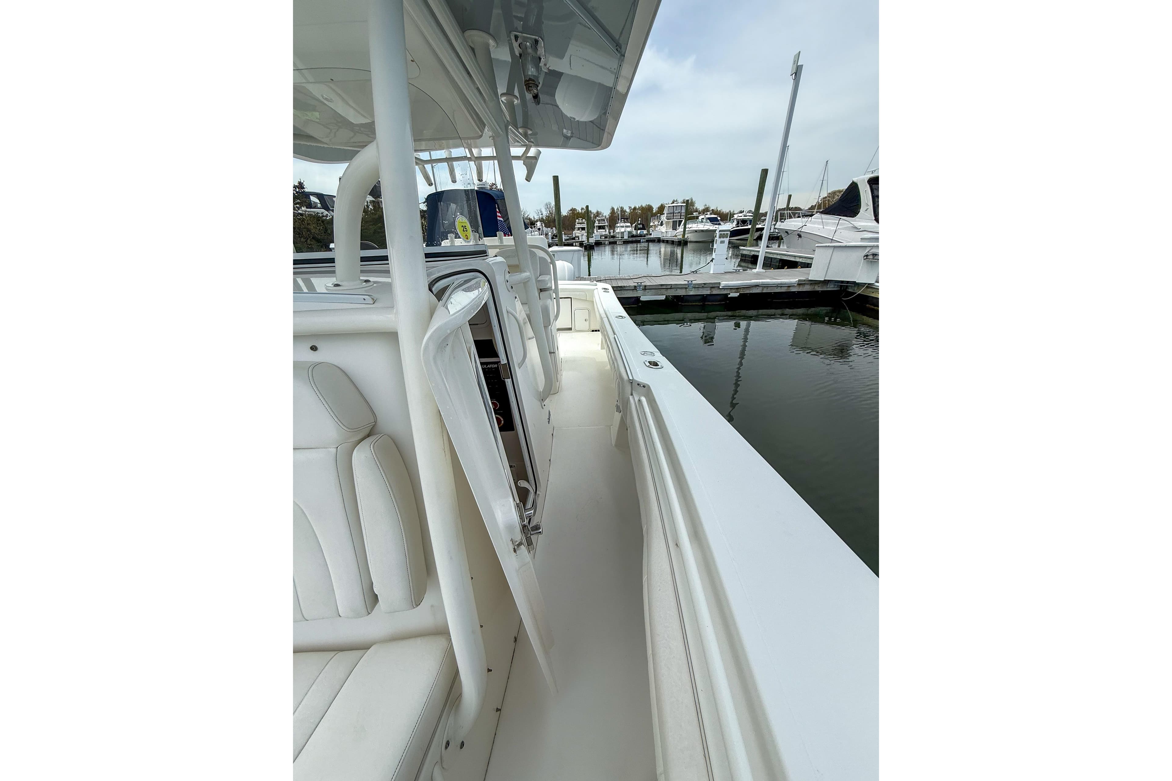2017 Regulator 31 boat docked at marina, showcasing sleek white interior and seating.