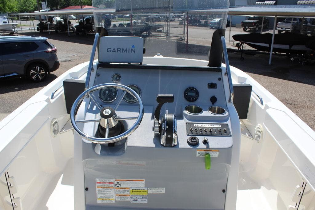2021 Bayliner T20CC boat dashboard with Garmin navigation system and steering wheel.