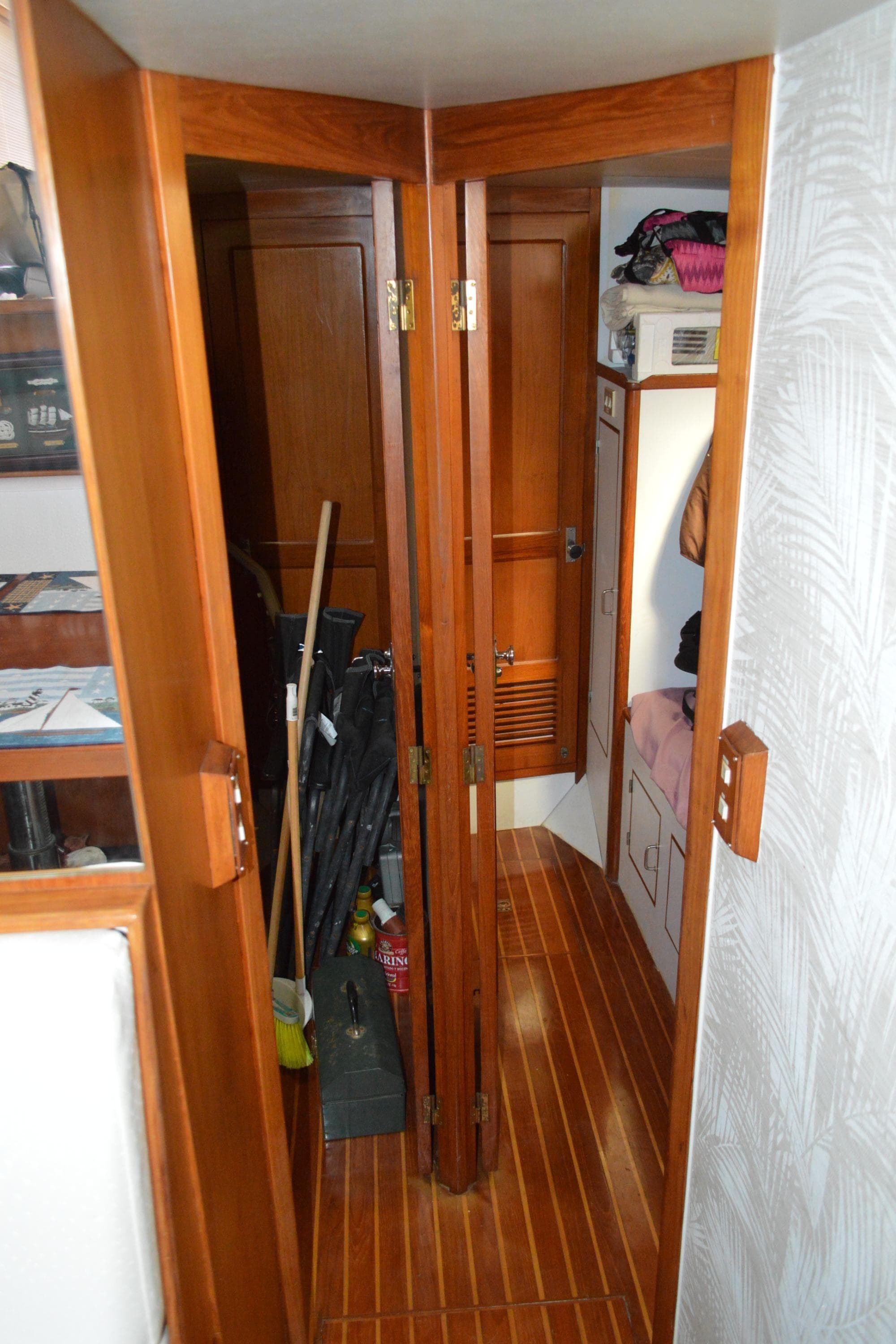Wooden interior of 1987 Symbol 51 yacht with storage and folding doors.