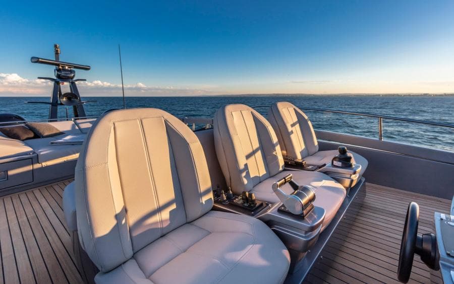 Luxurious 2024 Pershing 8X yacht deck with elegant seating and ocean view.