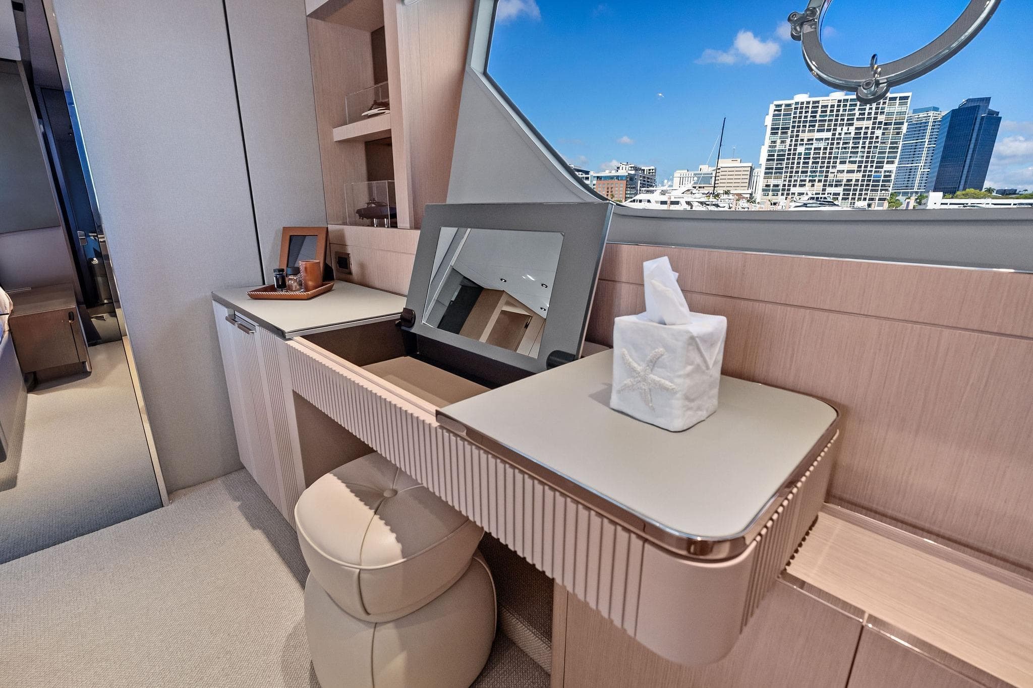 Luxurious interior of 2022 Ferretti Yachts 780 with elegant vanity and cityscape view.