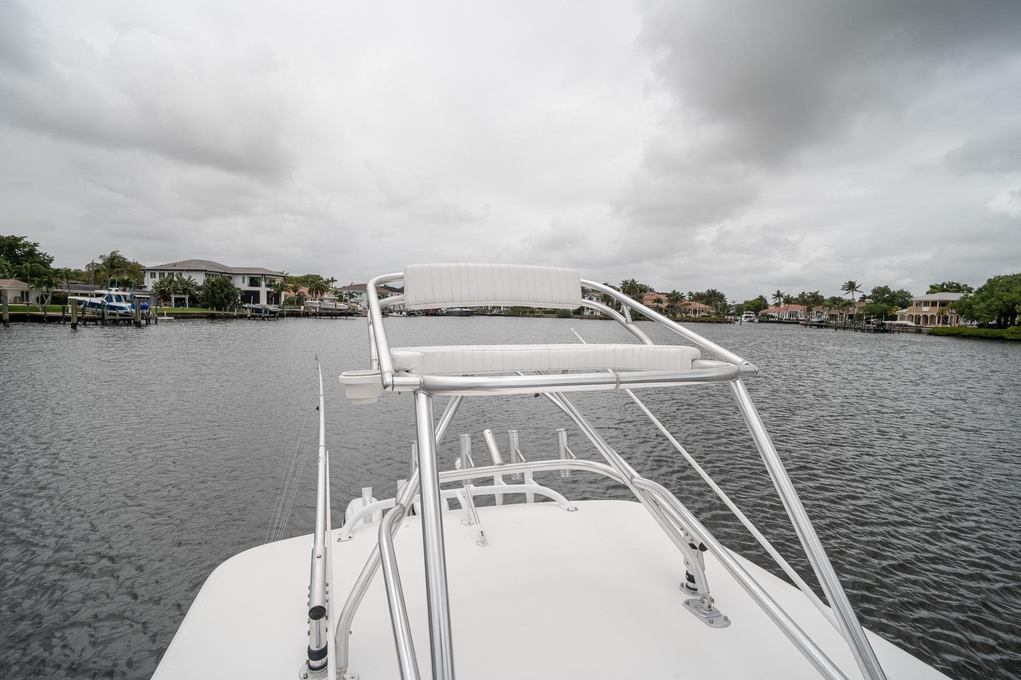 2006 Venture Center Console boat on a calm waterway under cloudy skies.