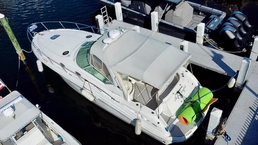 2006 Sea Ray 340 Sundancer docked at marina, aerial view.