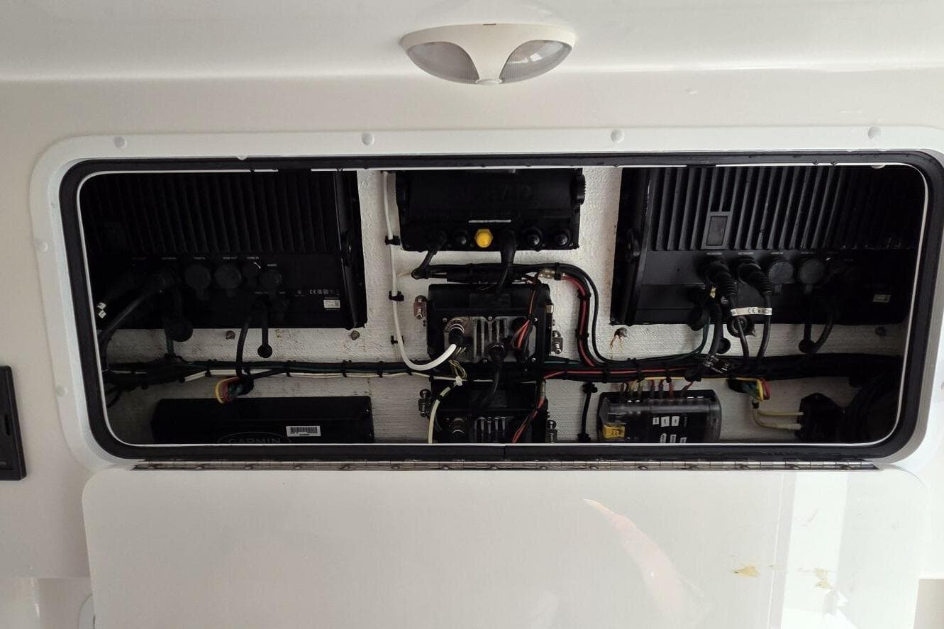 Electrical panel inside 2020 Invincible 35 Catamaran, showcasing wiring and components.