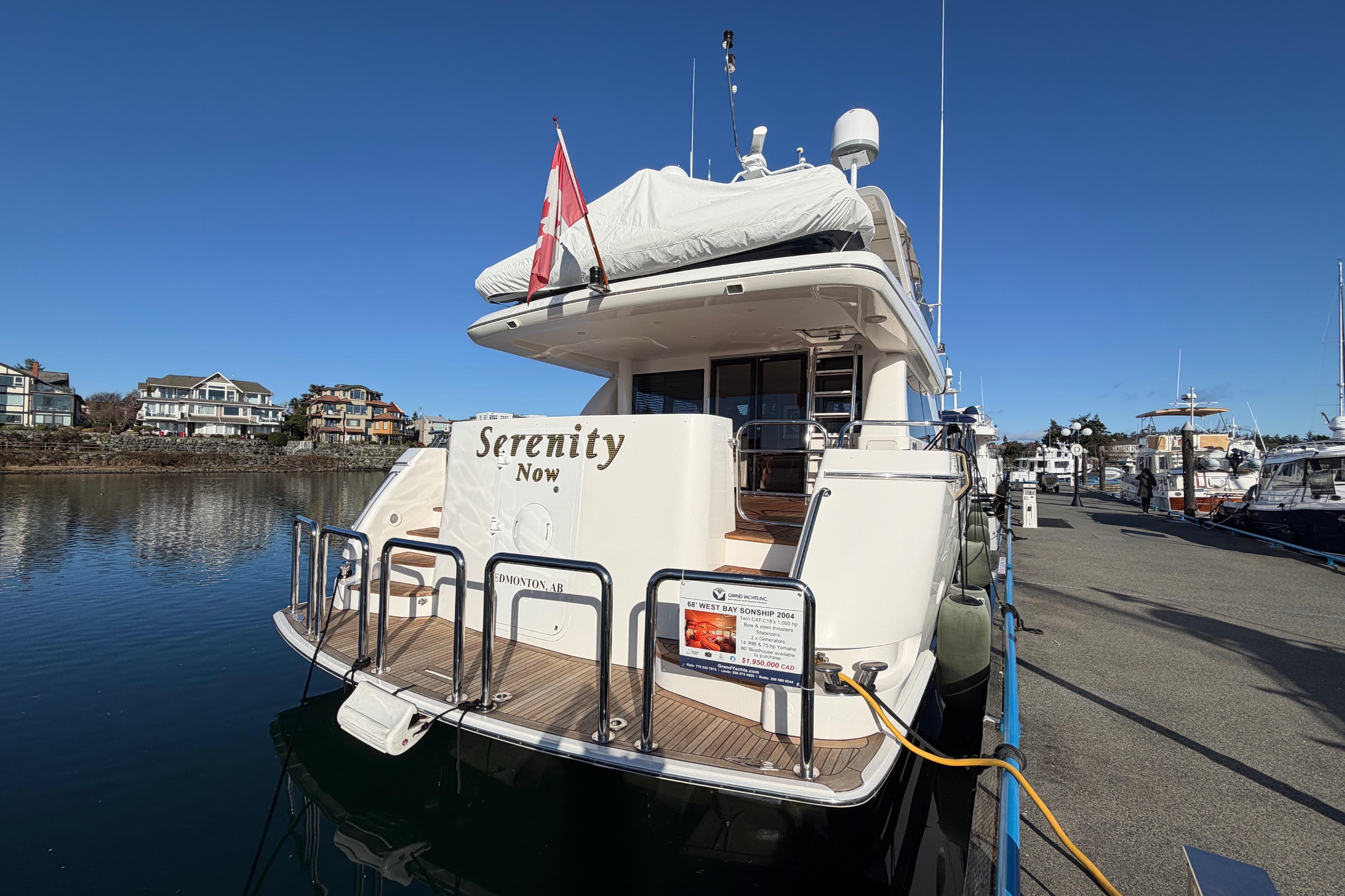 2004 West Bay 68 Sonship Pilothouse yacht docked, named "Serenity Now," with Canadian flag.
