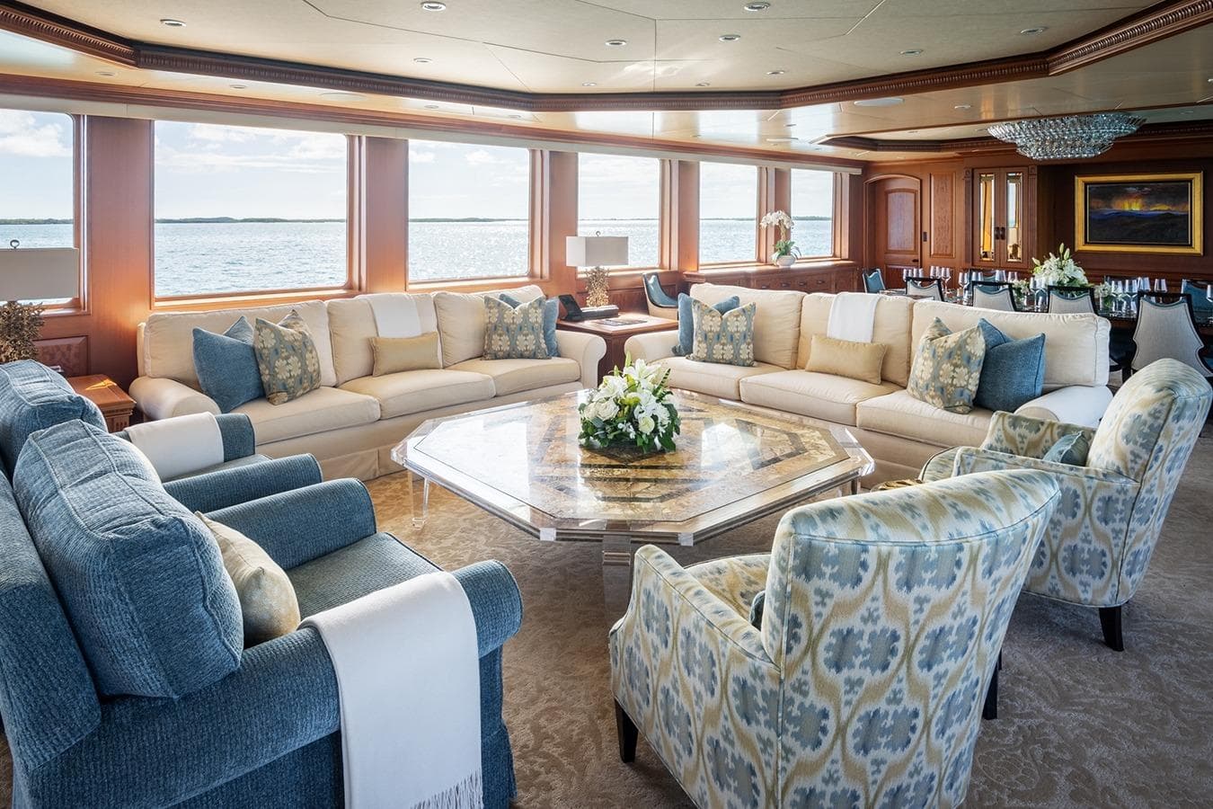 Luxurious yacht interior with elegant seating, large windows, and ocean view on a 2006 Burger Trideck.
