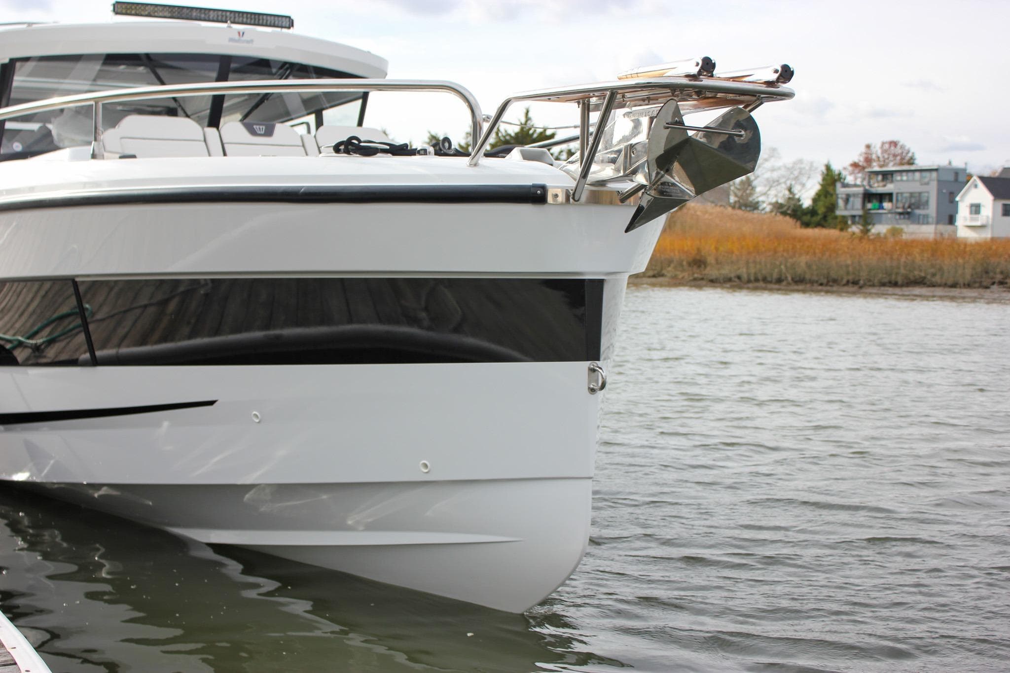 2026 Wellcraft 38 Explorer boat docked on calm water, showcasing sleek design and modern features.