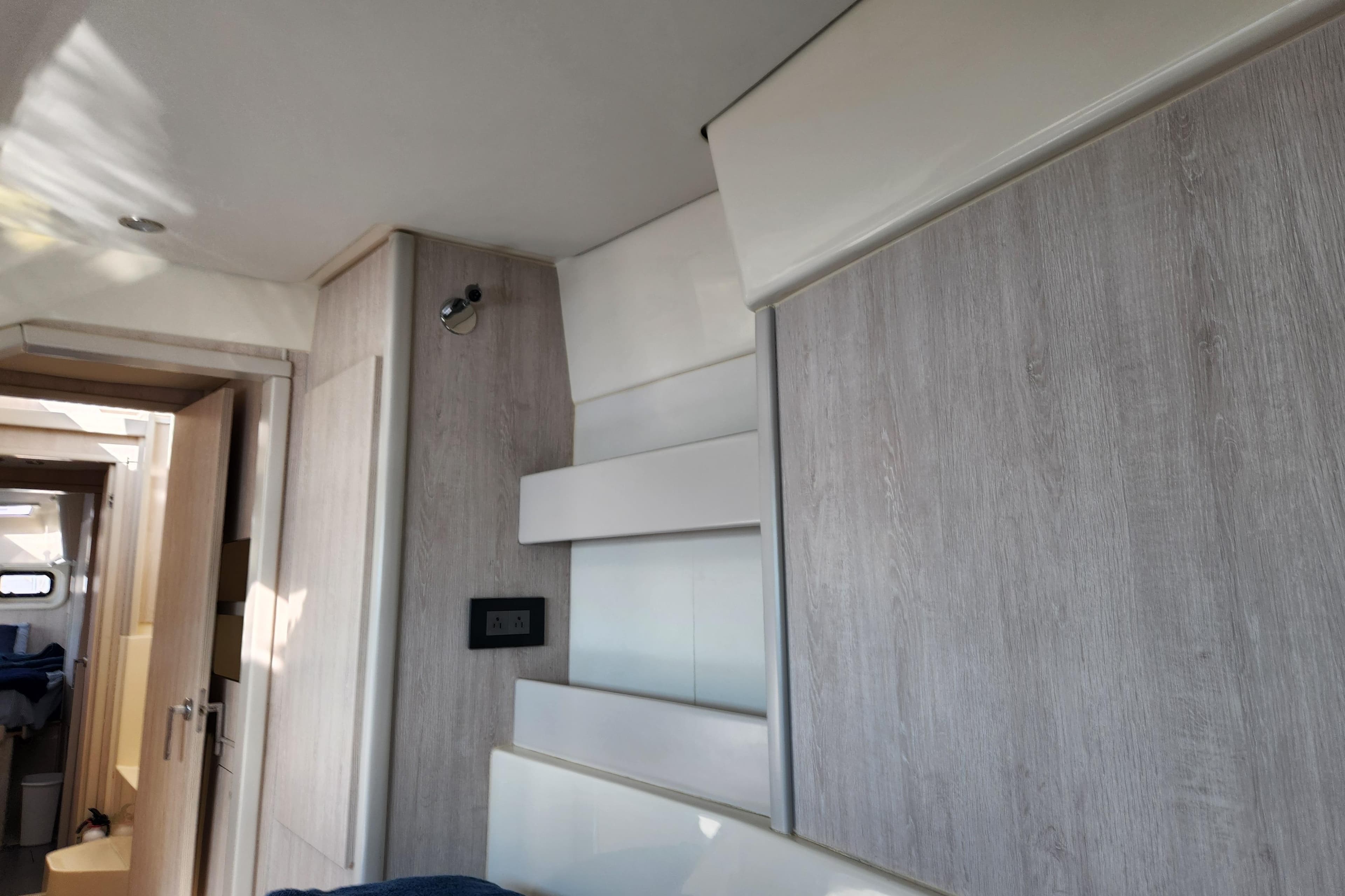Interior of a 2015 Leopard 44 yacht with modern wood paneling and lighting.