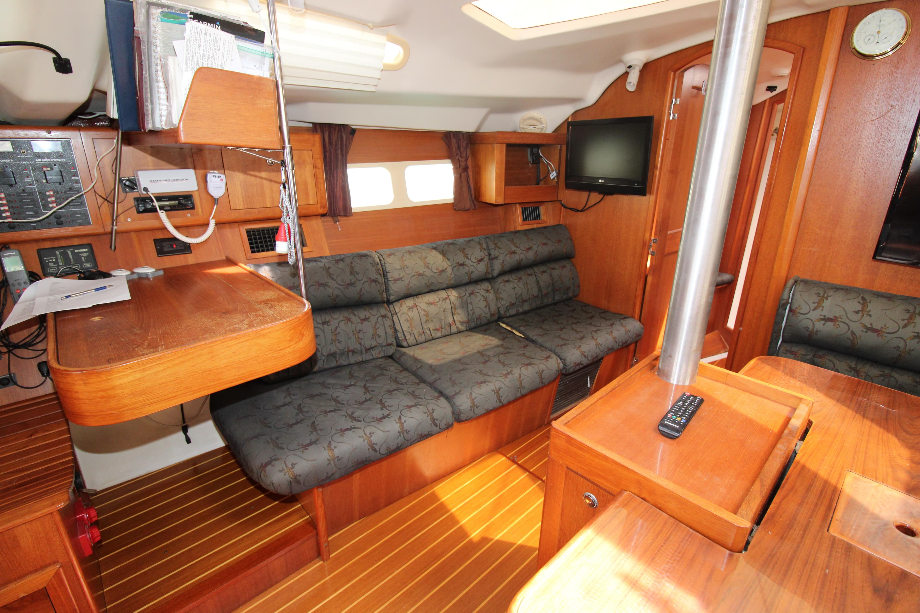 Interior of a 2002 Hunter 410 sailboat with wood finish and comfortable seating.