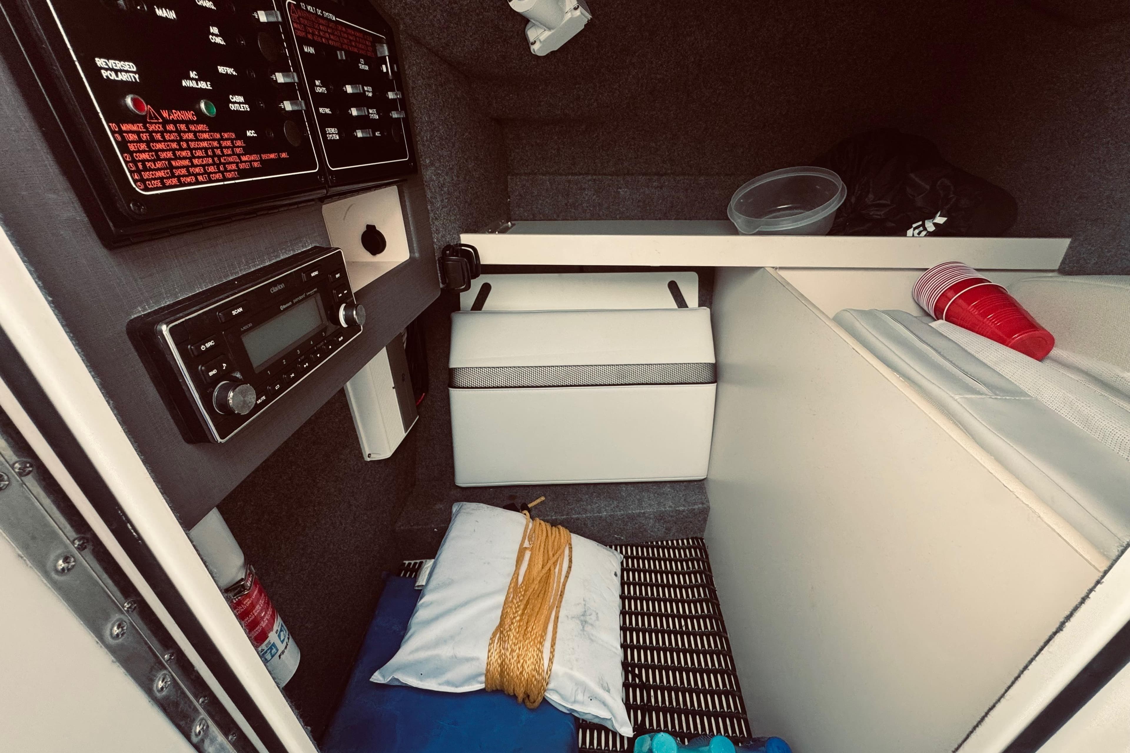 Interior of a 2019 Formula 310 FX Bowrider boat cabin with control panel and storage.