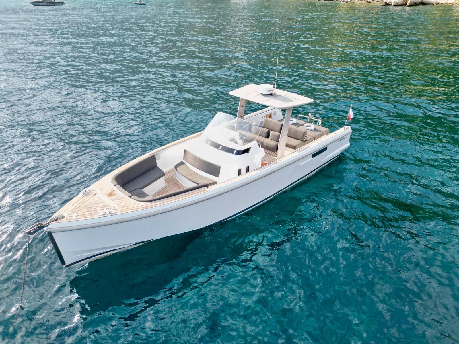 2017 Fjord 36 boat on clear blue water, showcasing sleek design and spacious deck.