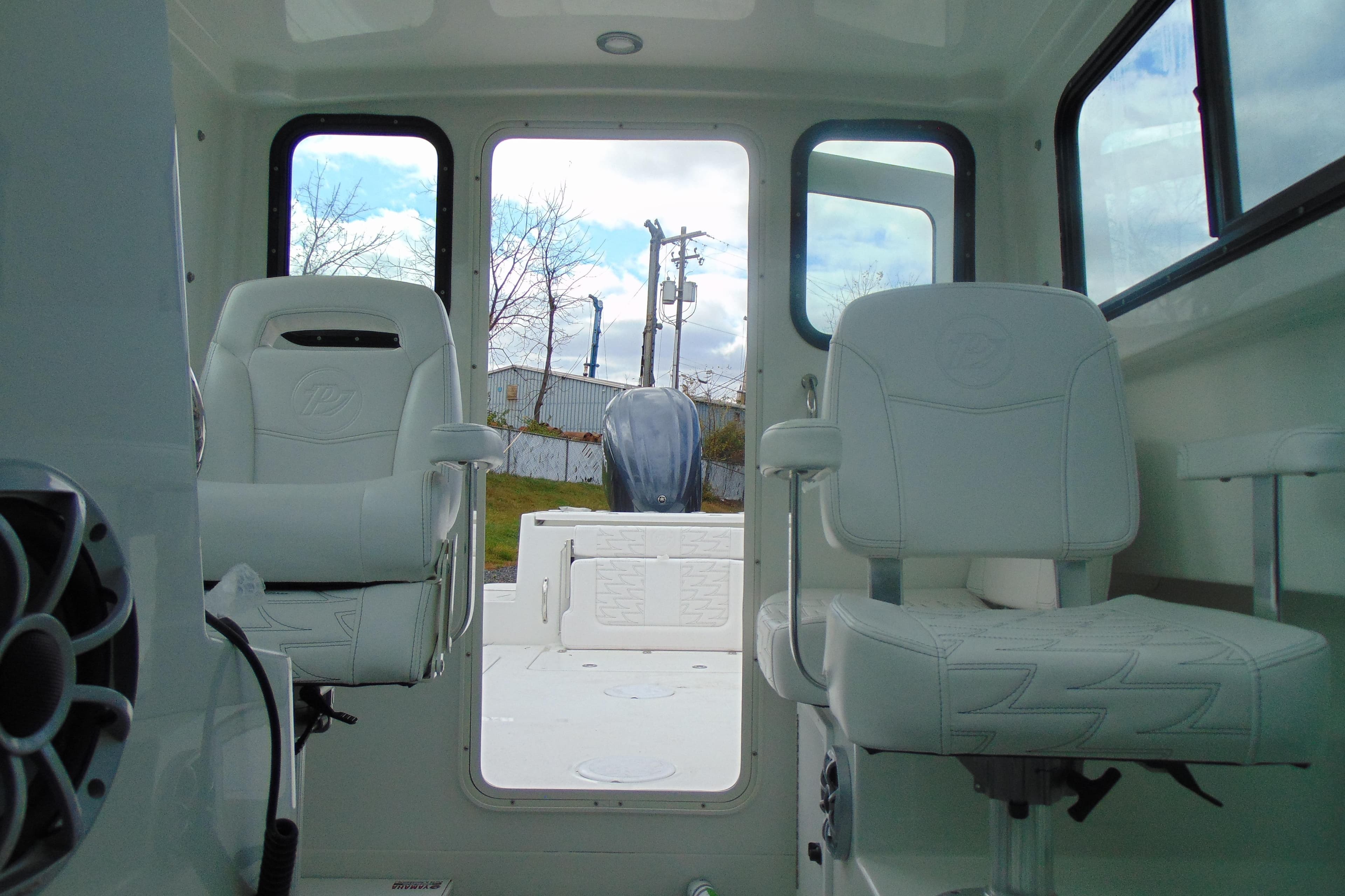 Interior of 2026 Parker 247 Explorer boat with white seating and open rear view.