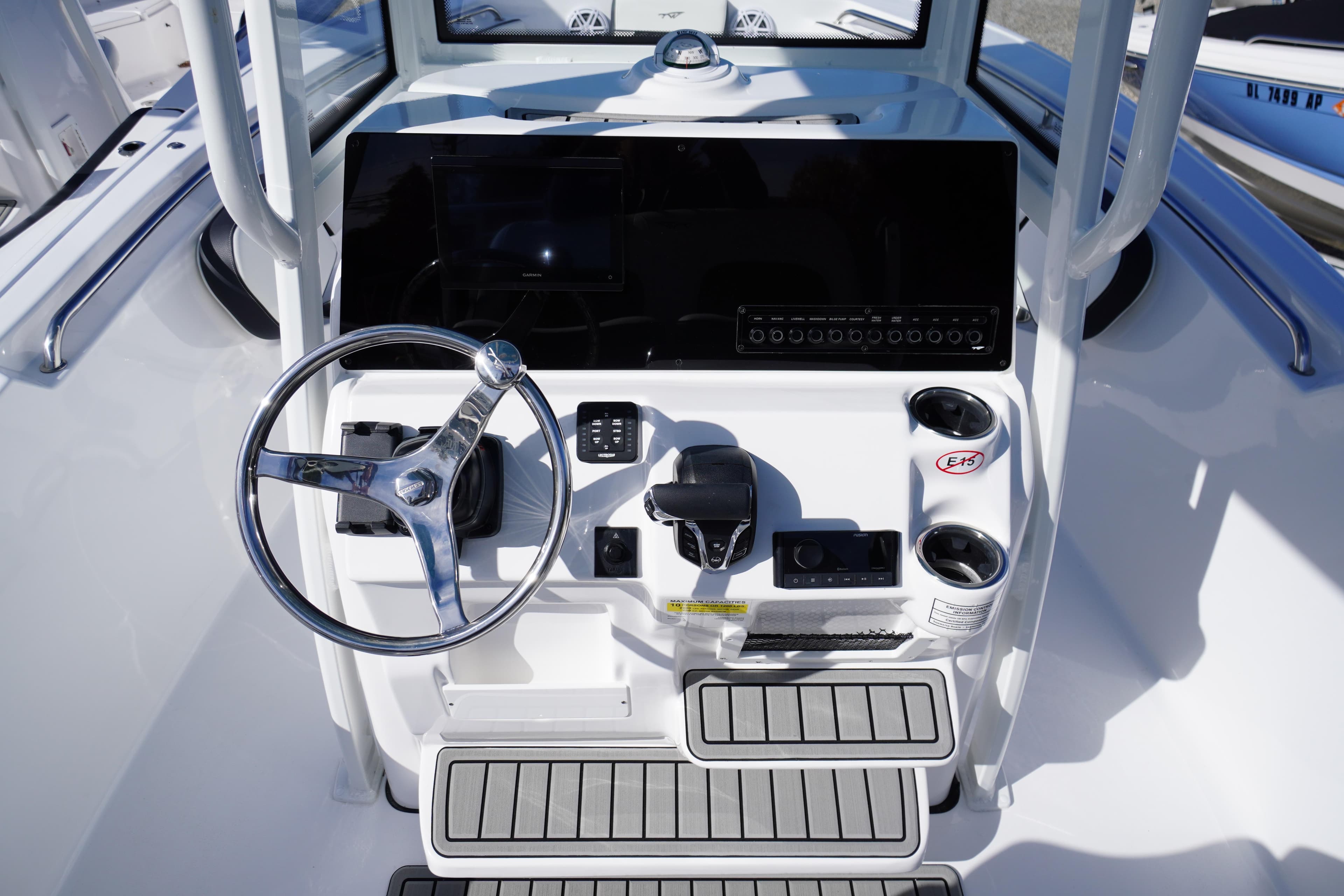 Steering console of 2026 Tidewater 220 LXF boat with modern controls and cup holders.