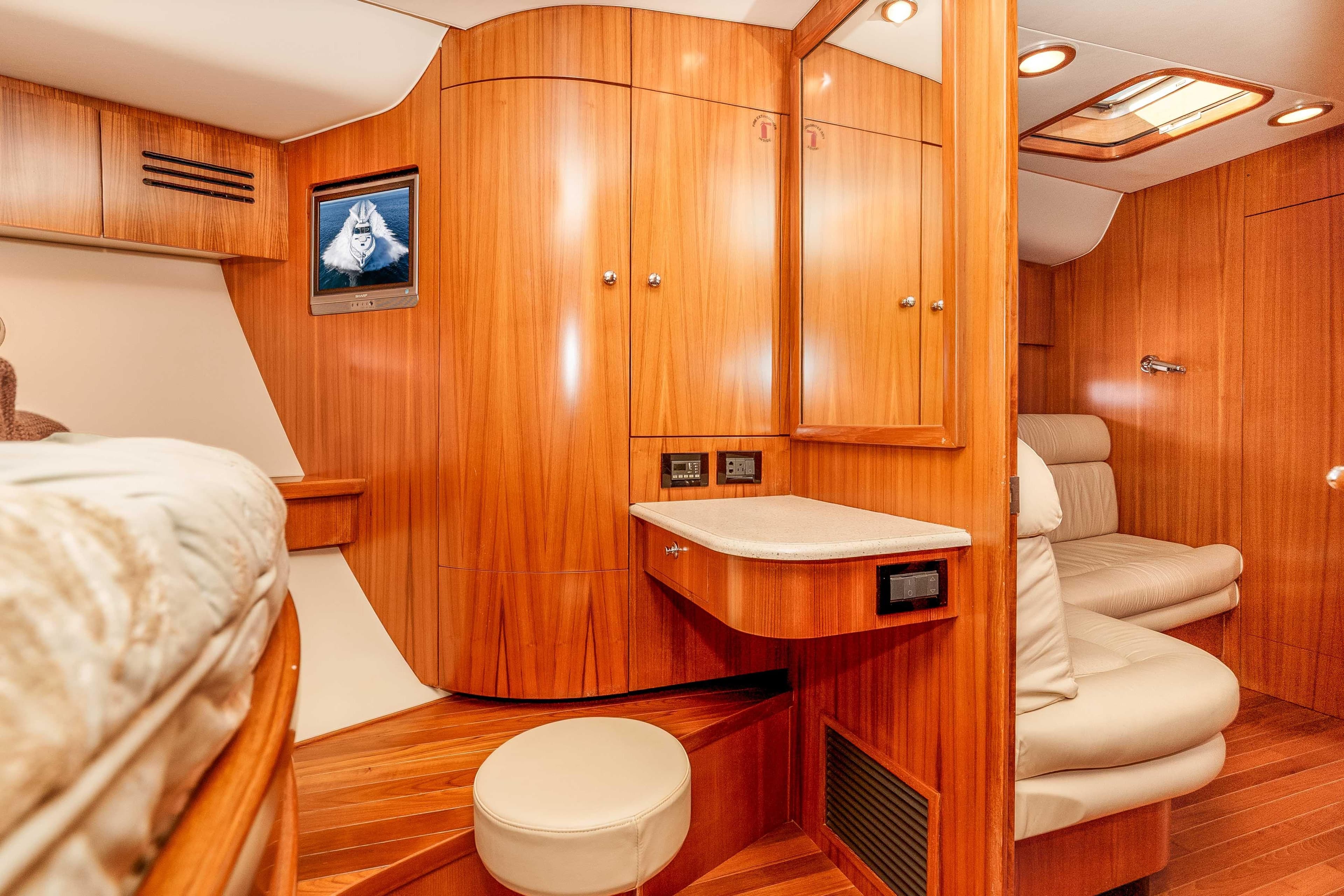Luxurious 2006 Tiara Yachts 5200 Sovran Salon interior with wood paneling and seating.