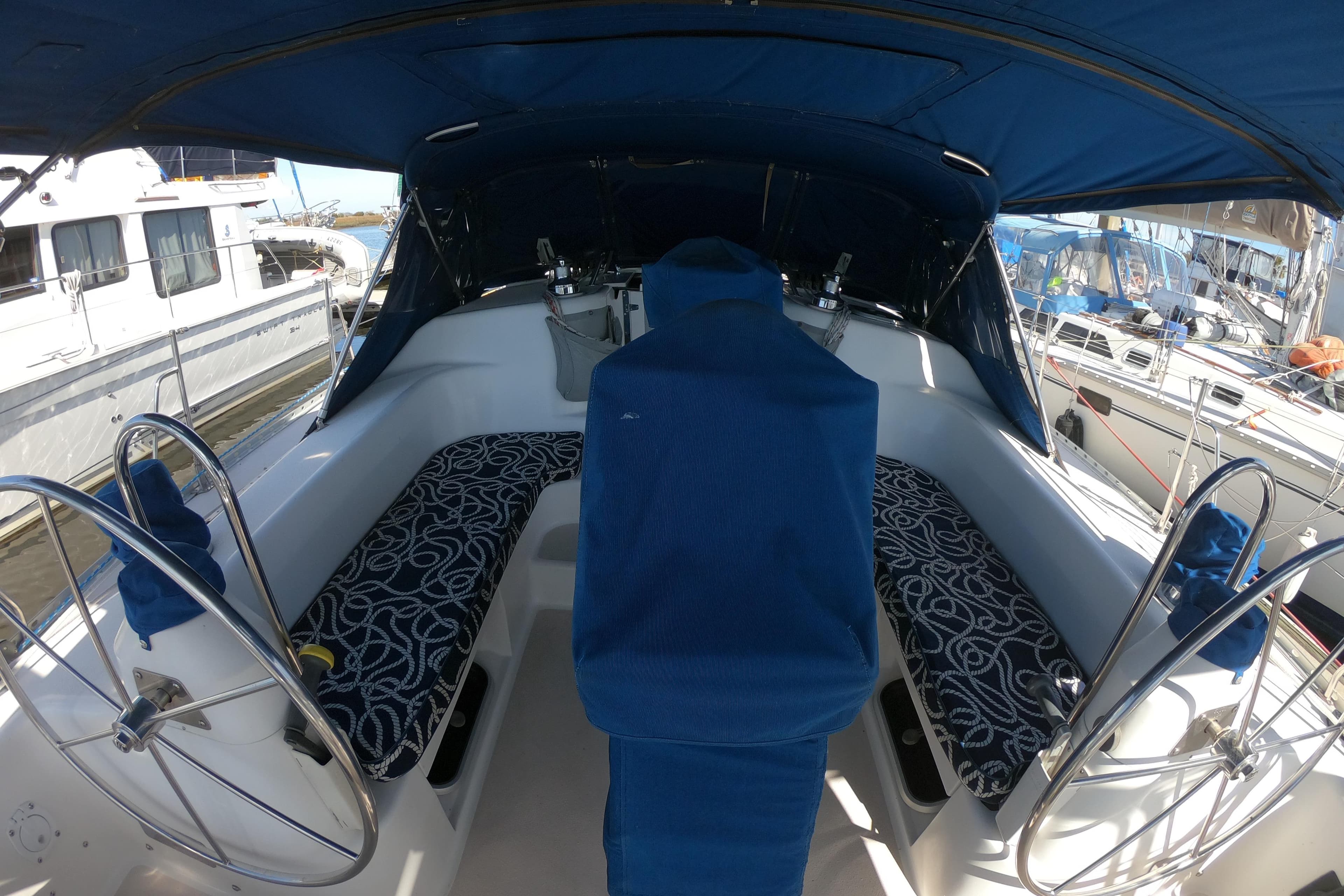 Cockpit of a 1998 Catalina 400 sailboat with blue seating and dual steering wheels.