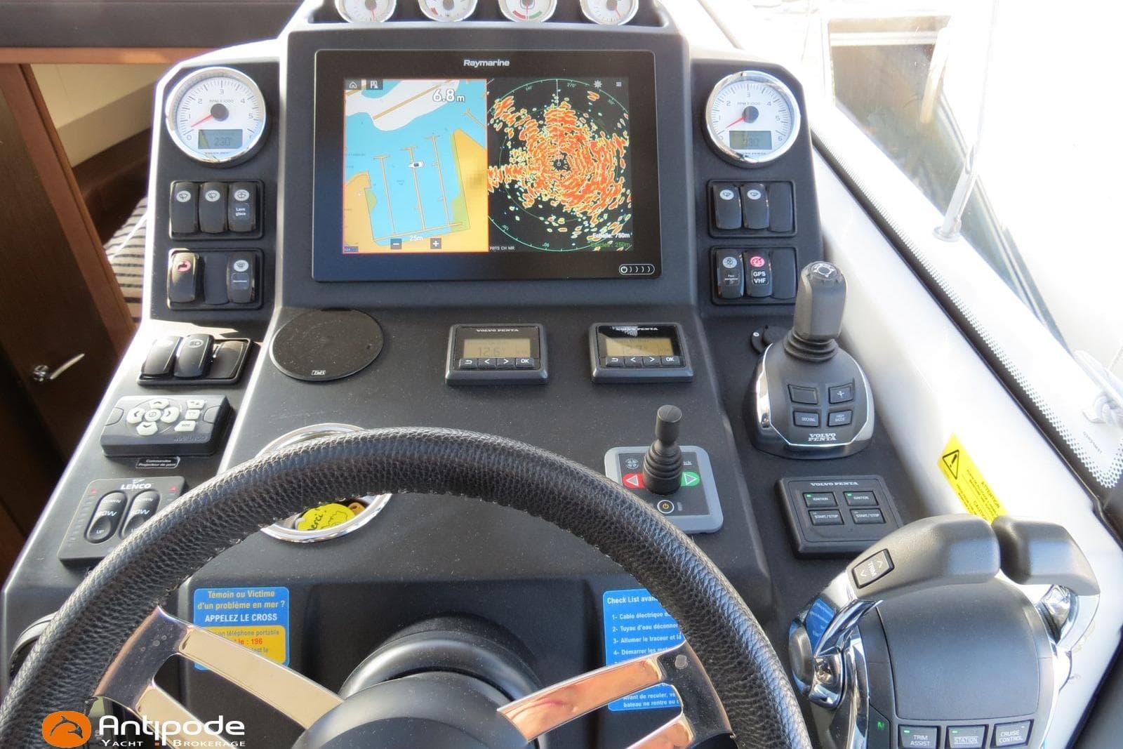 Cockpit of 2019 Jeanneau NC 33 with navigation controls and display screen.