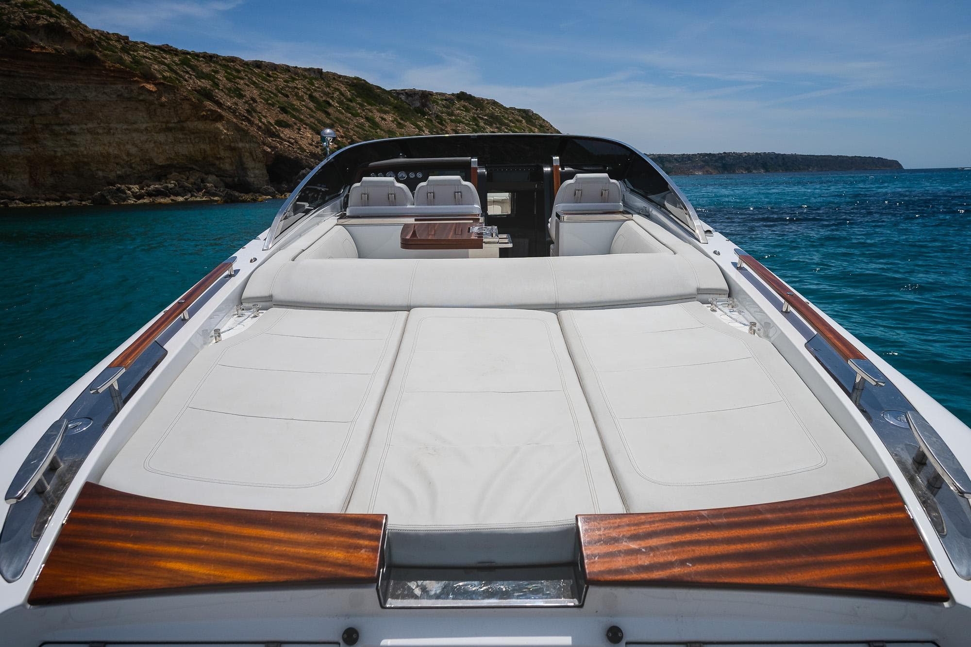 2022 Riva Rivamare luxury yacht with sun deck, cruising in clear blue waters.